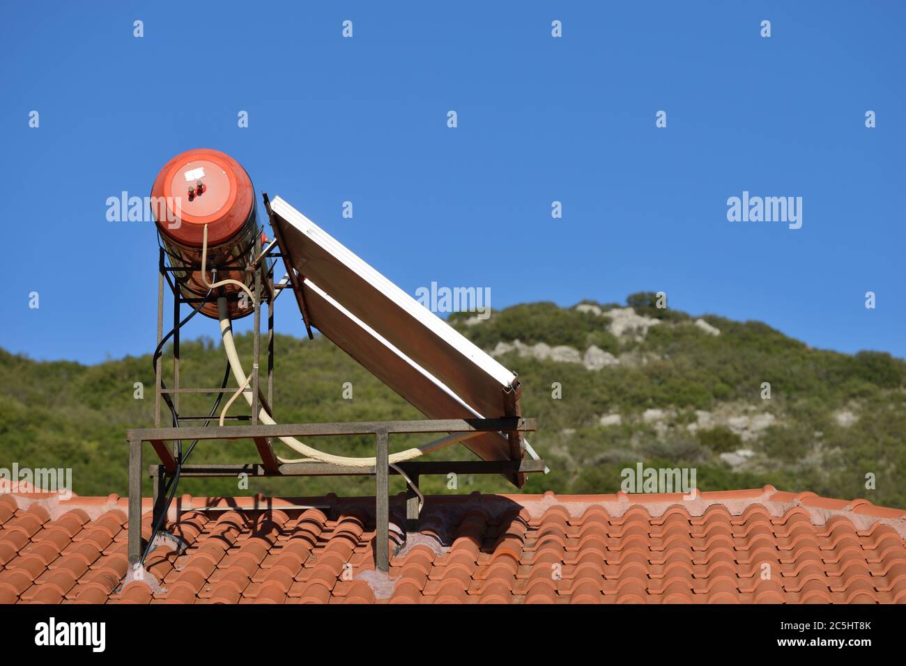 Solar water heater sits on the roof of a home in greek village, Greece  Stock Photo - Alamy