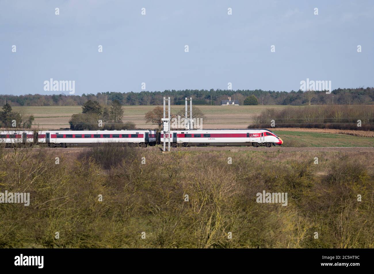 High speed train in LNER livery speeding through the English countryside. Stock Photo
