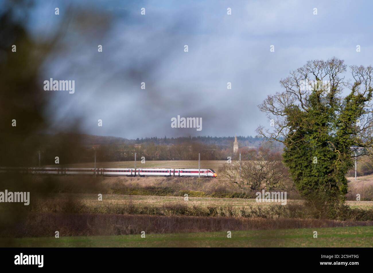 High speed train in LNER livery speeding through the English countryside. Stock Photo