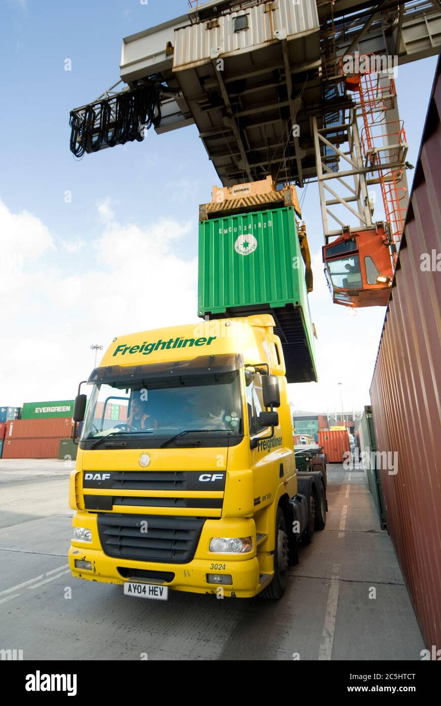 Rail mounted crane being used to load and unload shipping containers on HGV lorries at Manchester Euroterminal, Trafford Park, Manchester, England. Stock Photo