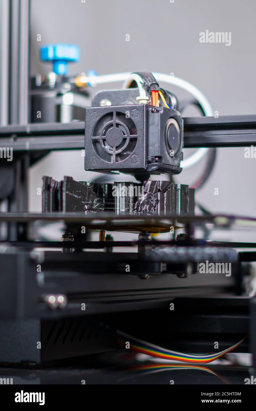 3D plastic printer during work in a factory three dimensional printing. Close-up detail. Stock Photo