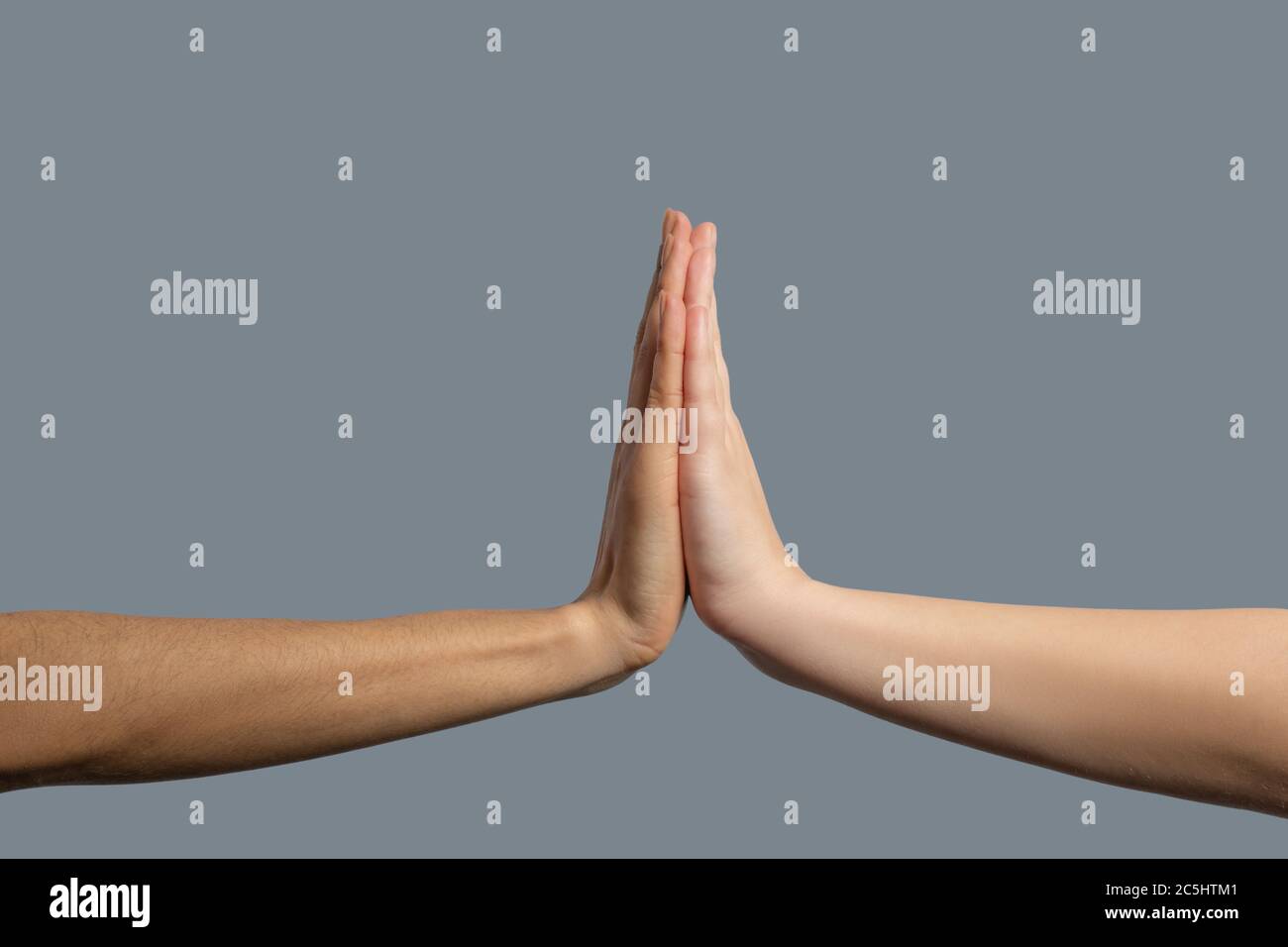 Close-up of people from different races holding palms together Stock Photo