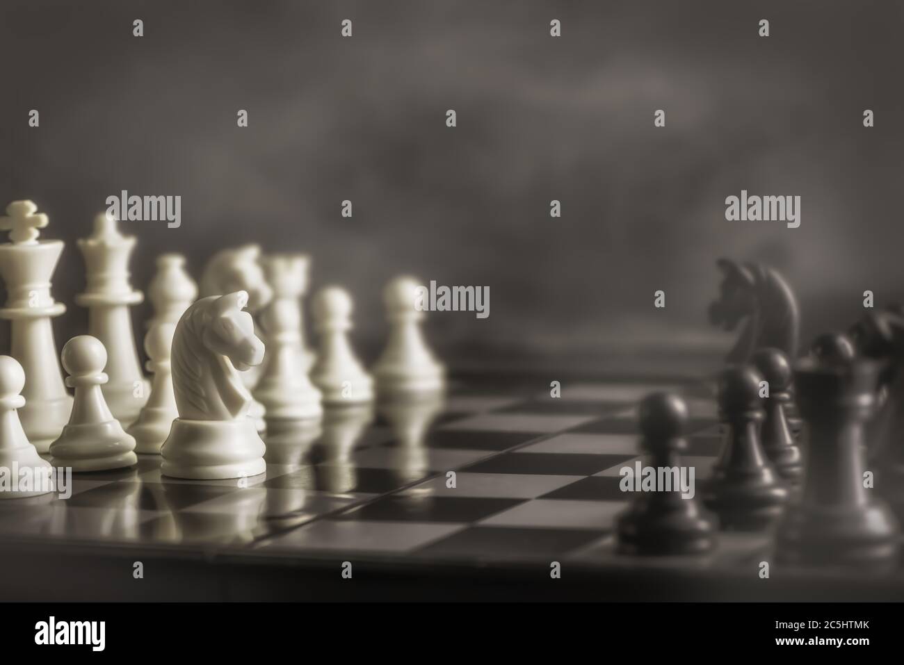 black and white chess on a chessboard. Horse. International Chess Day. copy space. retro, sepia Stock Photo