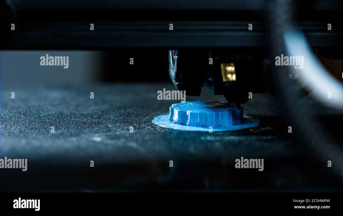 3D plastic printer during work in a factory three dimensional printing. Close-up detail. Stock Photo