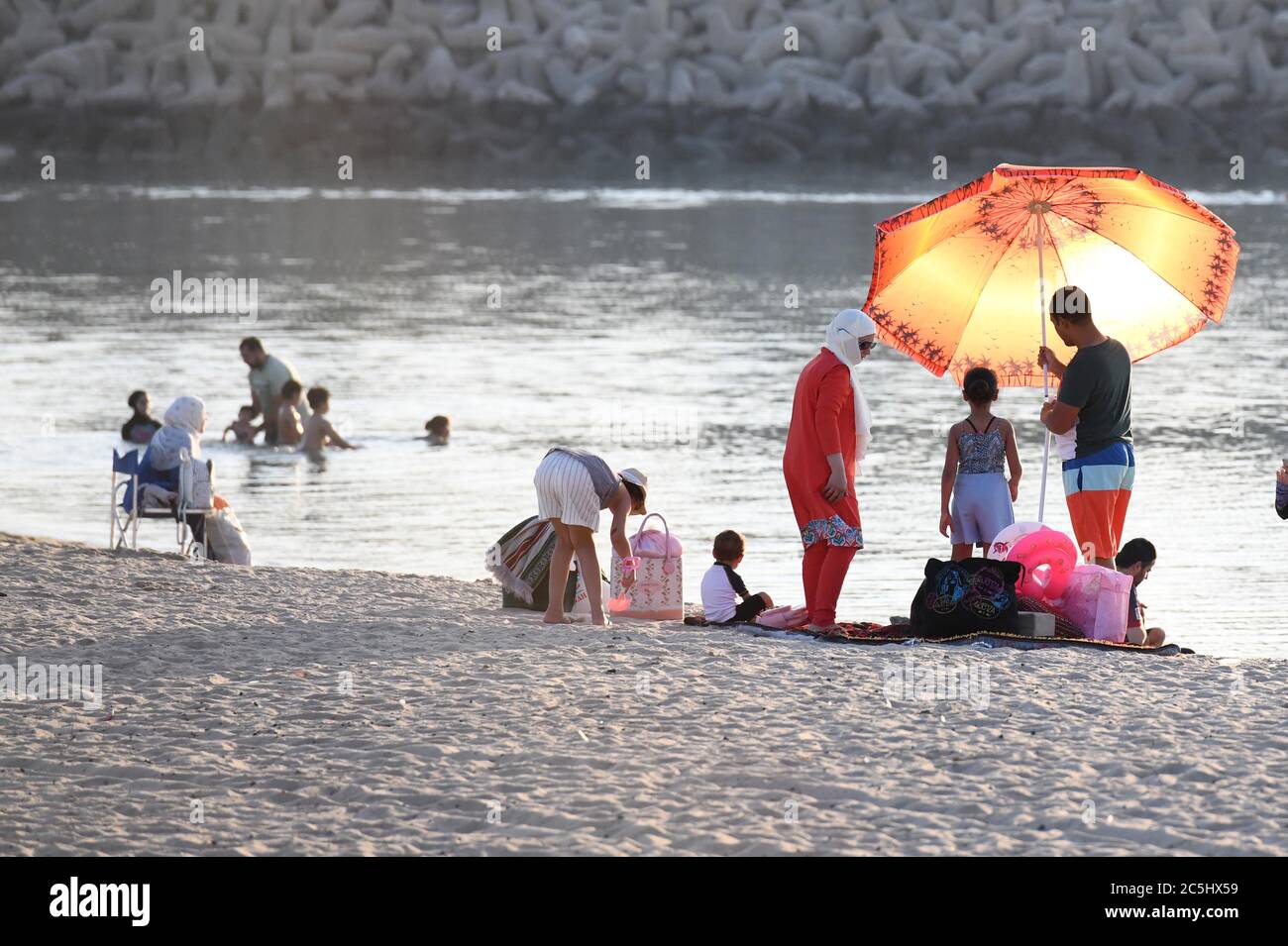 Kuwait City, Kuwait. 3rd July, 2020. People relax on a beach in the
