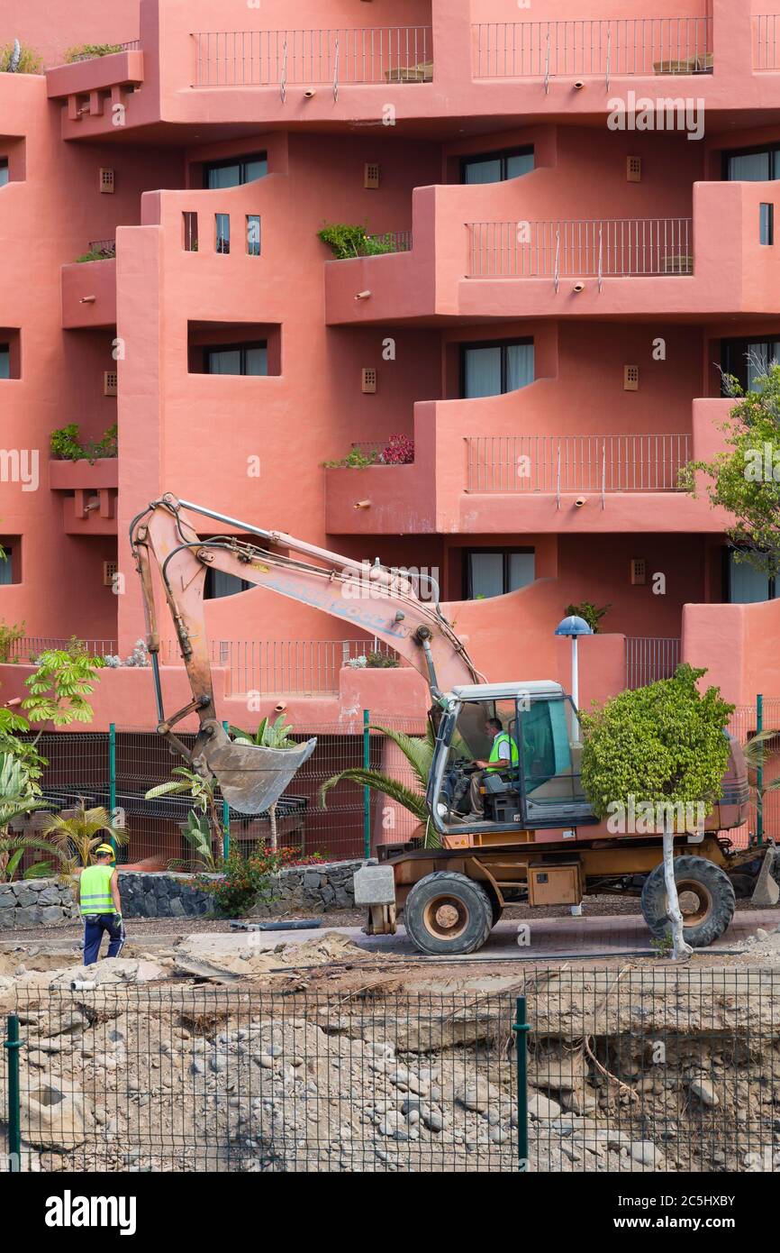 TENERIFE, CANARY ISLANDS - May 17, 2018. Bulldozer digging, building work making noise and ruining holiday next to hotel rooms, Costa Adeje Stock Photo
