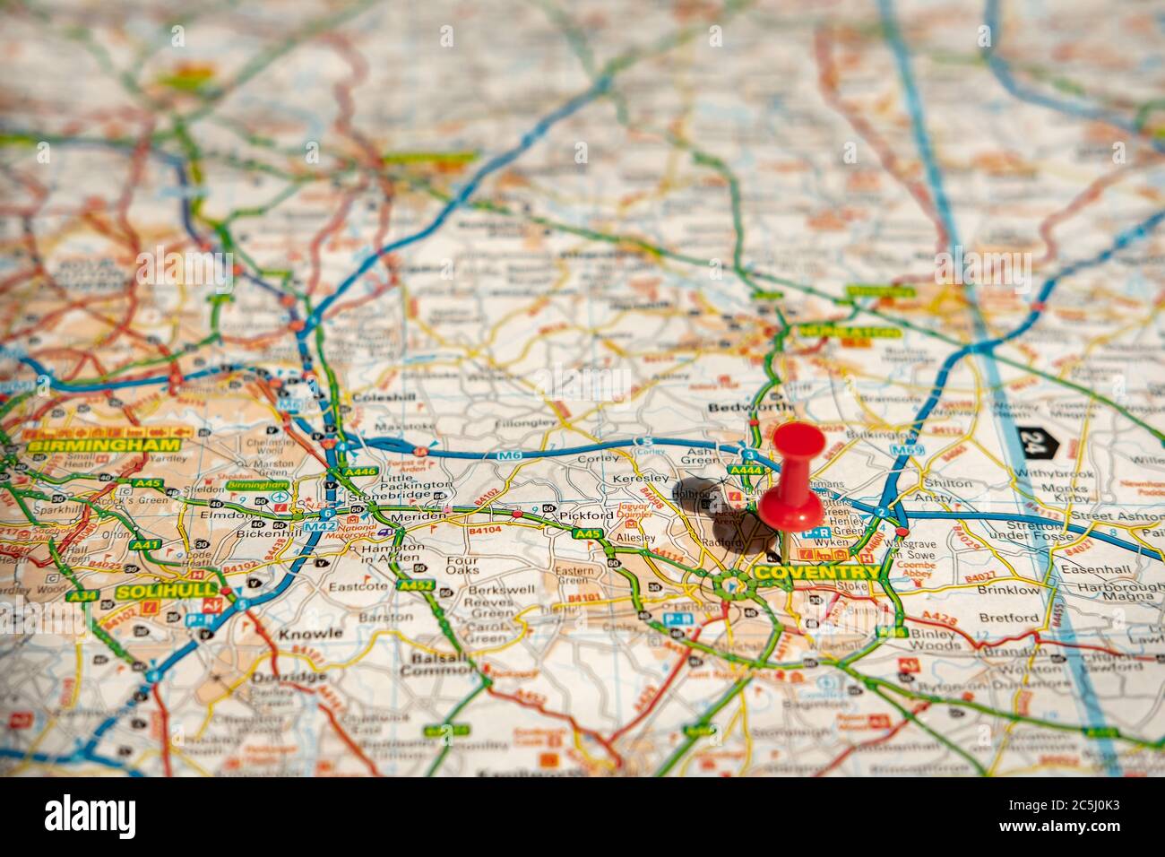 Shallow focus of a red push-pin located at this historic english city centre. Stock Photo