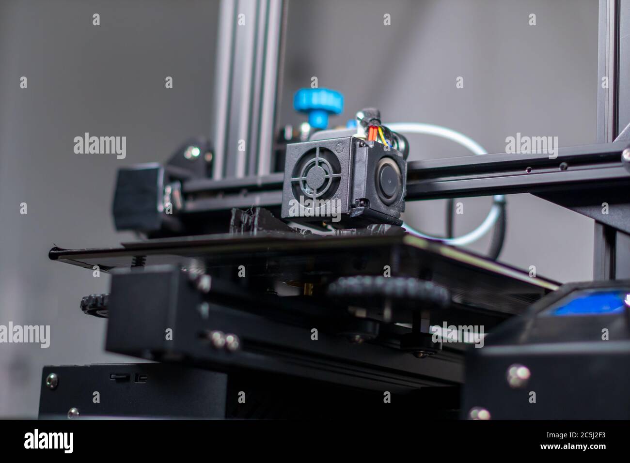 3D plastic printer during work in a factory three dimensional printing. Close-up detail. Stock Photo