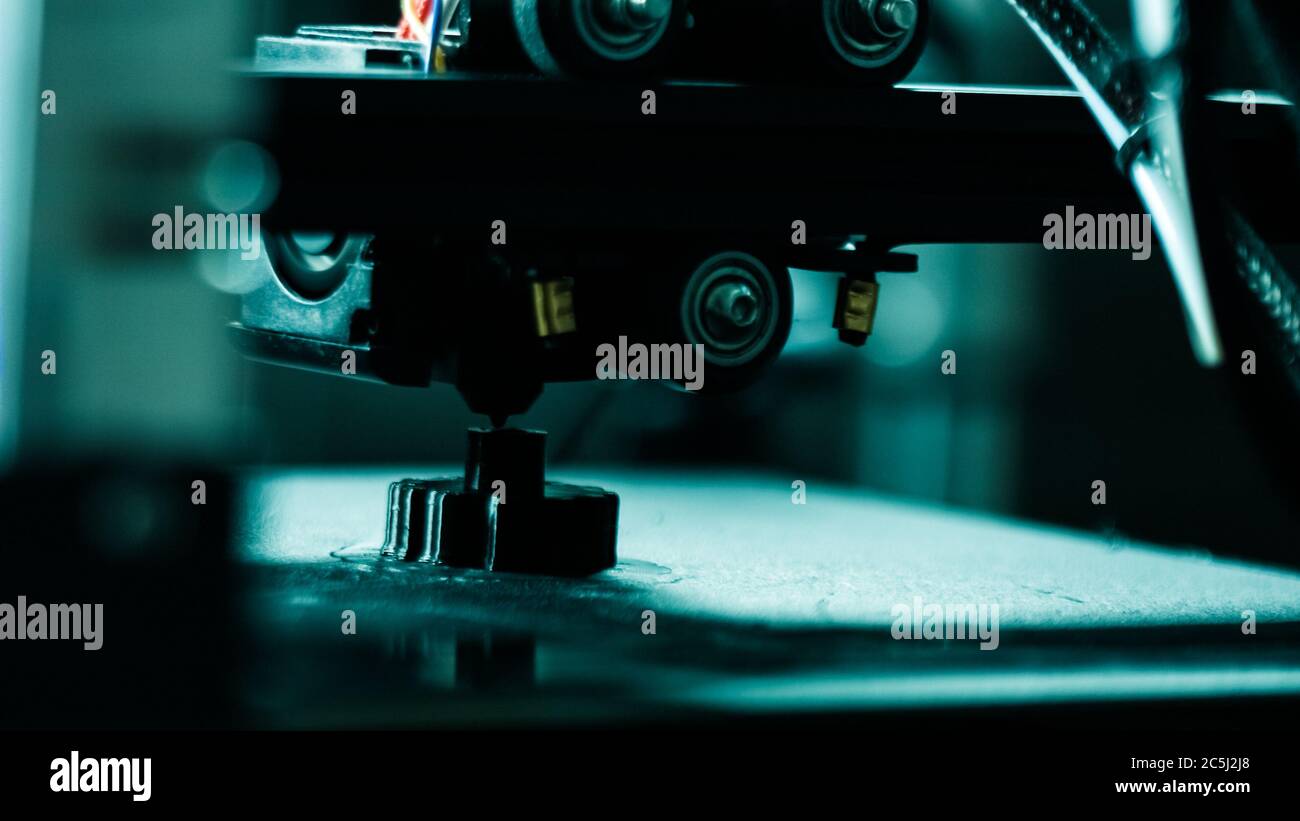 3D plastic printer during work in a factory three dimensional printing. Close-up detail. Stock Photo