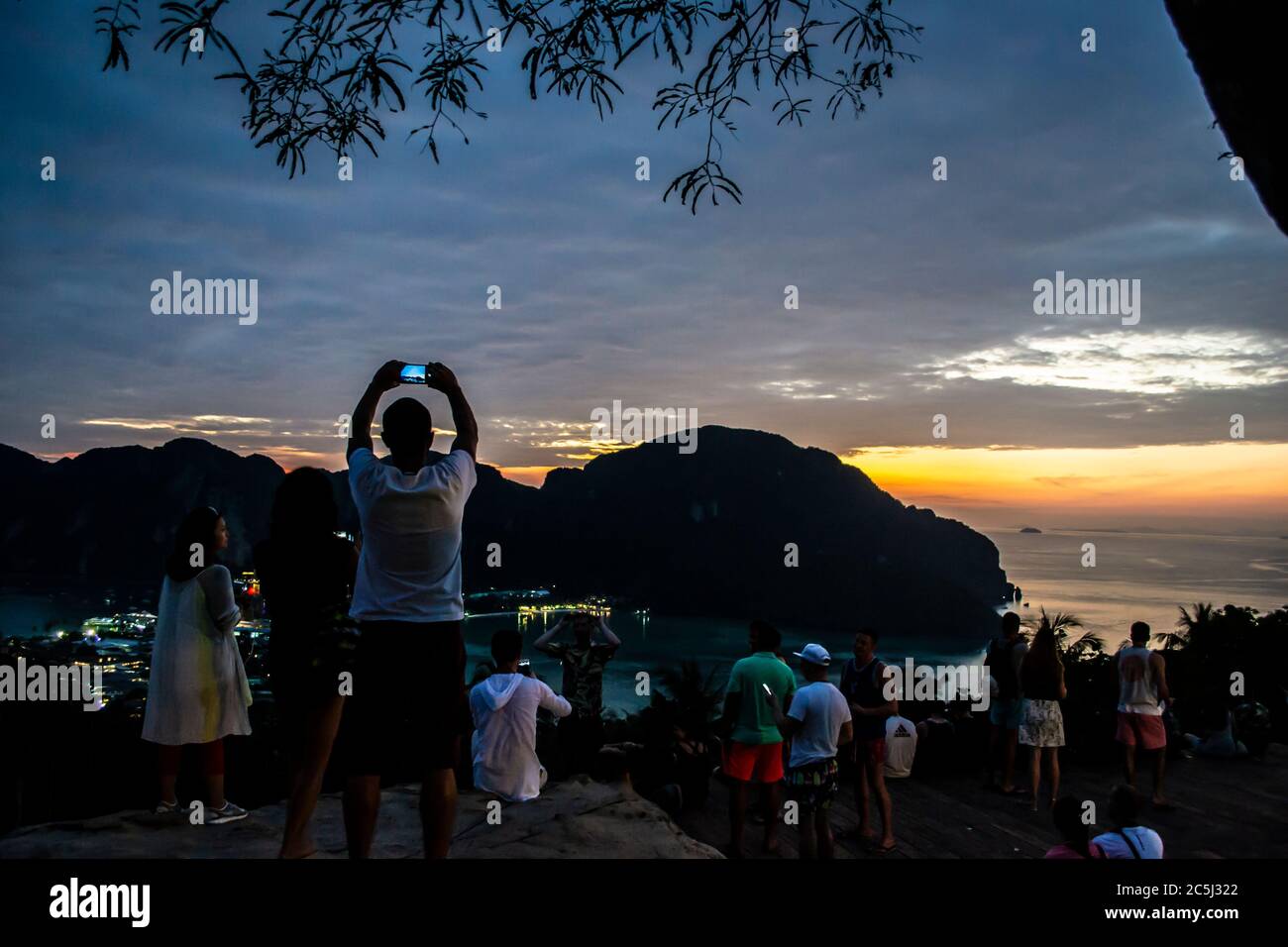 People watching Koh Phi Phi viewpoint at sunset, Thailand Stock Photo