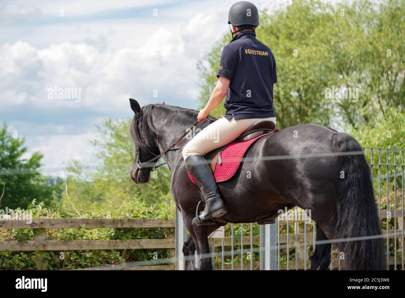 Young student rider seen crossing a railway track at a designated ...