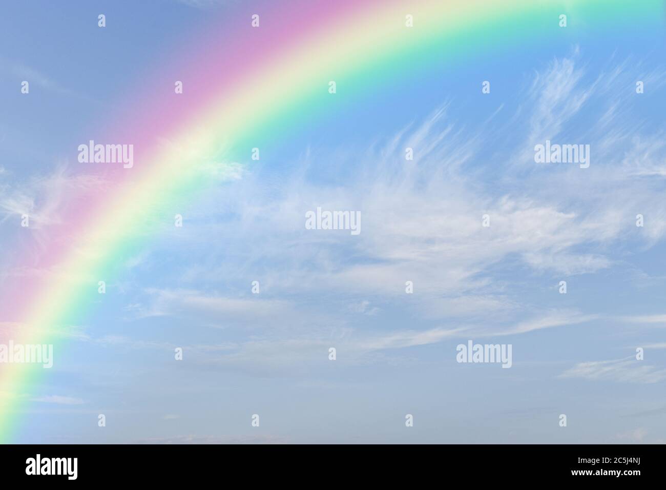 Rainbow on blue sky with white cloud background. Stock Photo