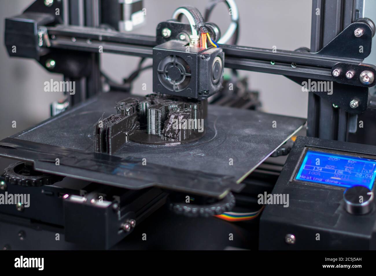 3D plastic printer during work in a factory three dimensional printing. Close-up detail. Stock Photo