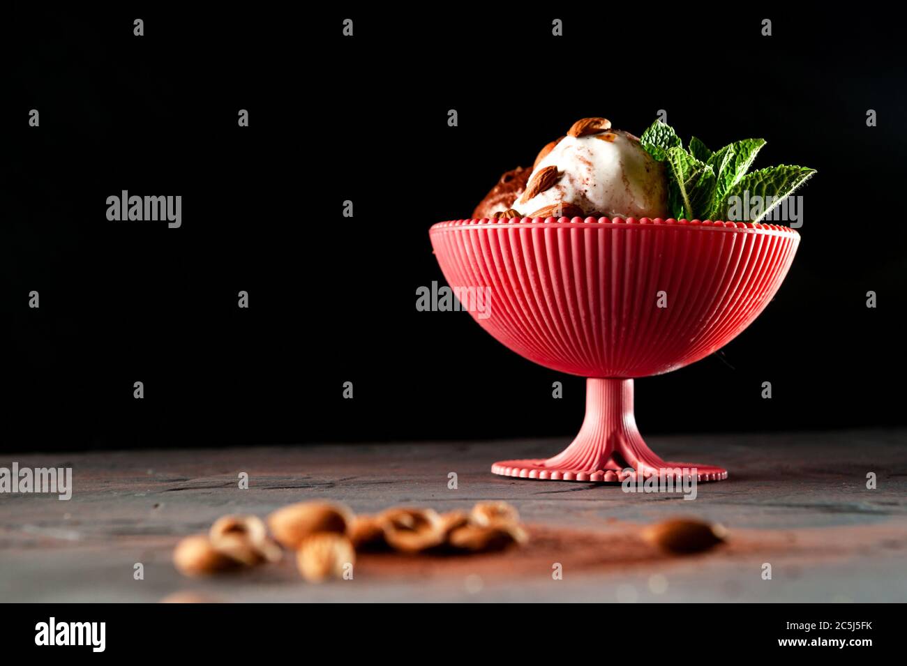ice cream with mint and cocoa on a gray background in a pink cup. Top view and flat lay Stock Photo