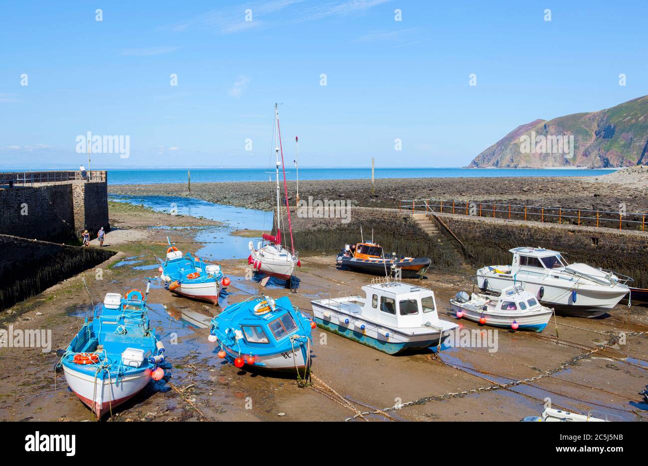 Boats moored in Lynmouth harbour at low tide on the North Devon coast. Stock Photo