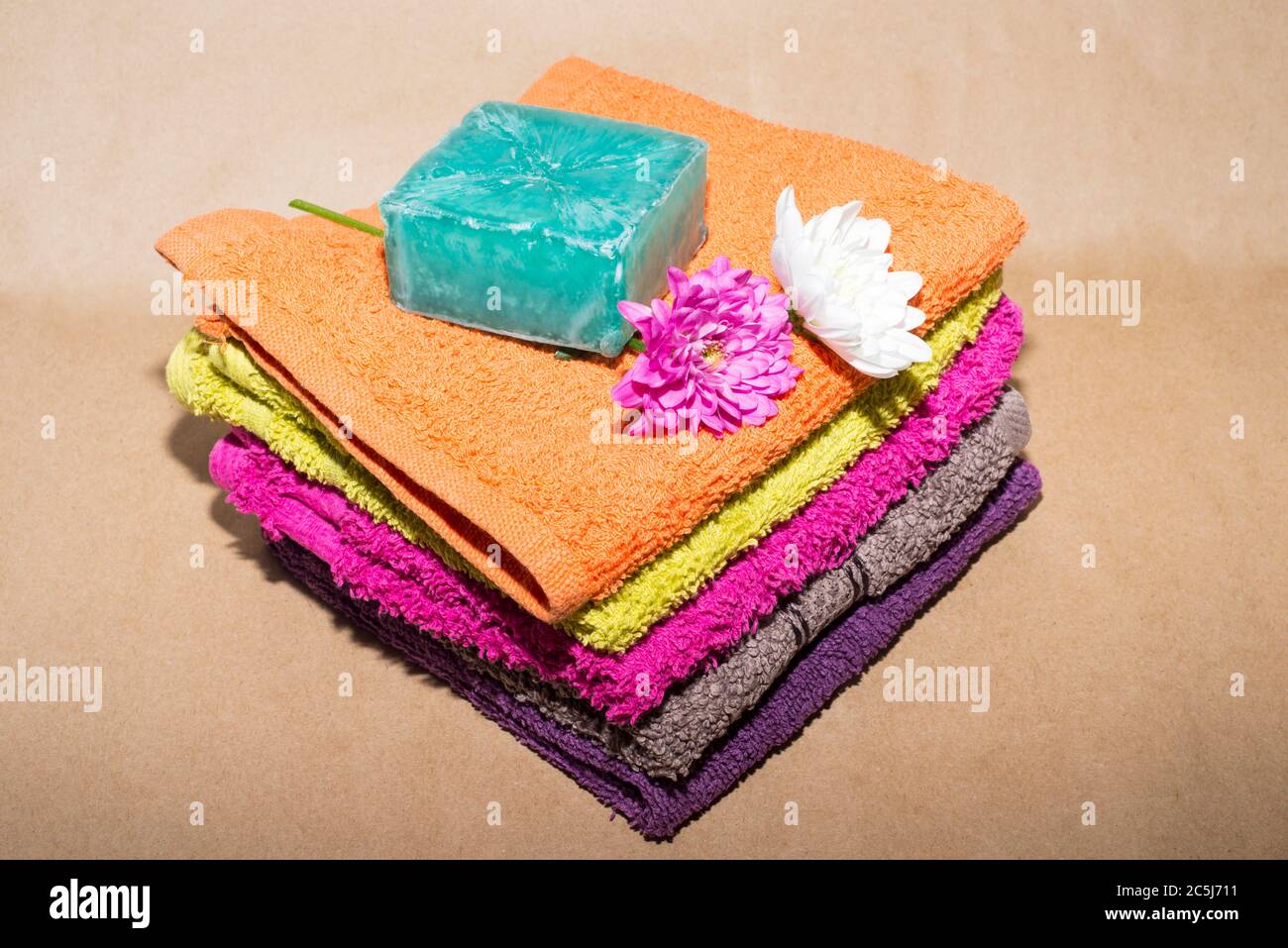 soap bar on top of facecloths off various shades with flowers Stock Photo