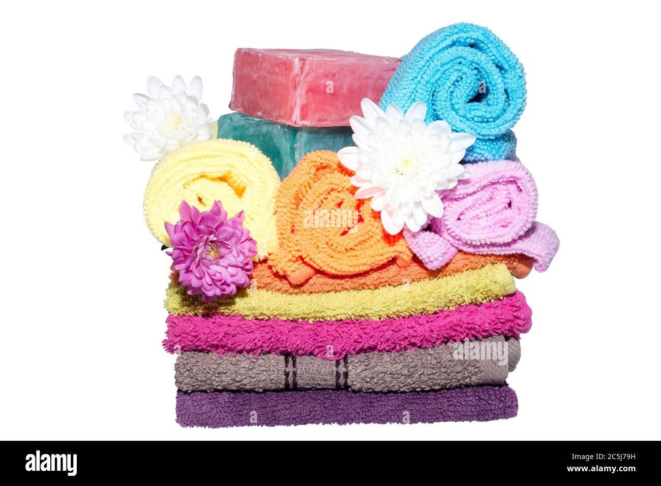 soap bars on facecloths off various shades with some in rolls and flowers Stock Photo
