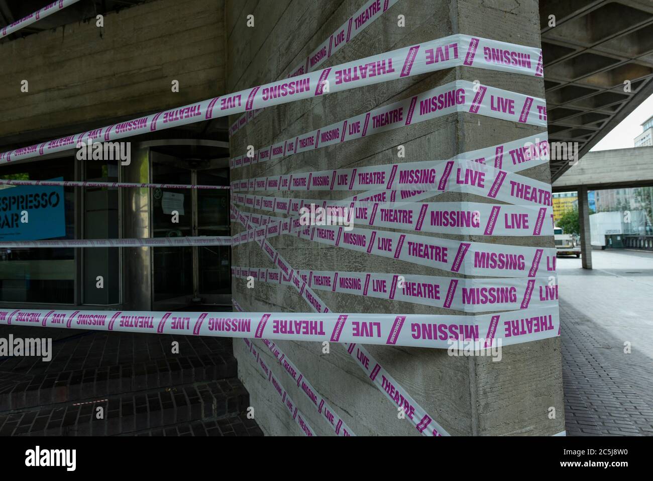 London, UK.  3 July 2020.  Pink tape has been wrapped around the National Theatre on the South Bank as part of the #MissingLiveTheatre initiative, a project by theatre designers Scene Change to support those in the live theatre industry through Covid-19 and to help theatres bring shows back into production.  So far, 50 theatres across the UK have signed up to the initiative.  Theatres are remain closed even though the UK government has relaxed certain coronavirus pandemic lockdown restrictions allowing other businesses to reopen.    Credit: Stephen Chung / Alamy Live News Stock Photo