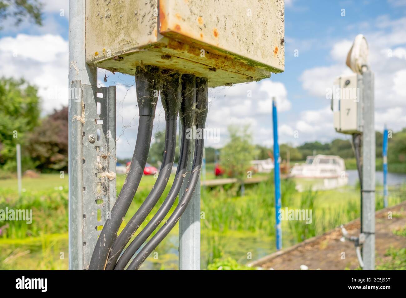 Detailed view of a rusting electrical junction box located at a boating
