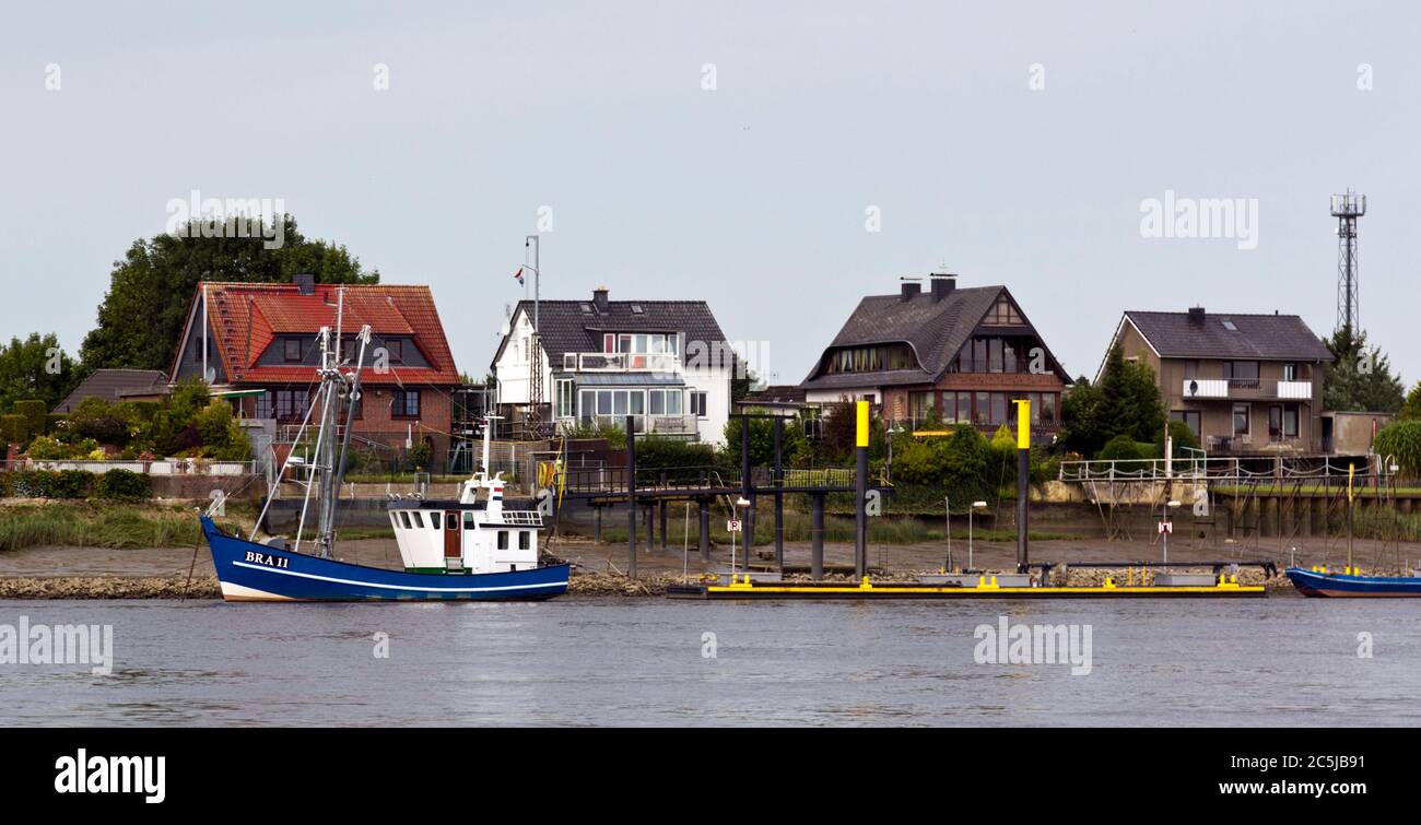 Houses on the banks of River Weser, Brake, Germany Stock Photo