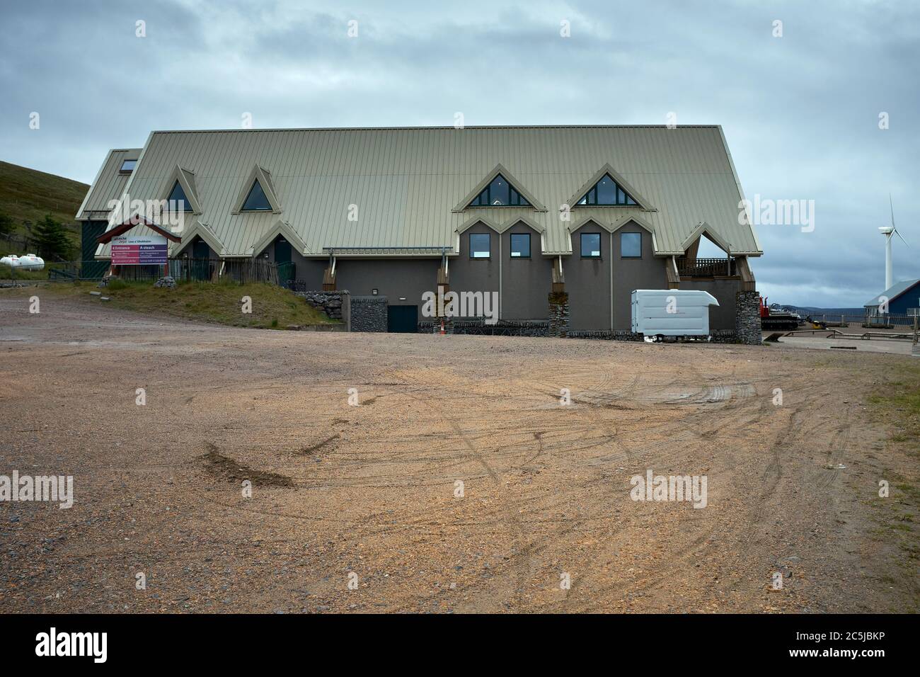 During a rainy July and out of season, a view of the empty rear gravel covered car park at the Lecht Ski Centre Stock Photo