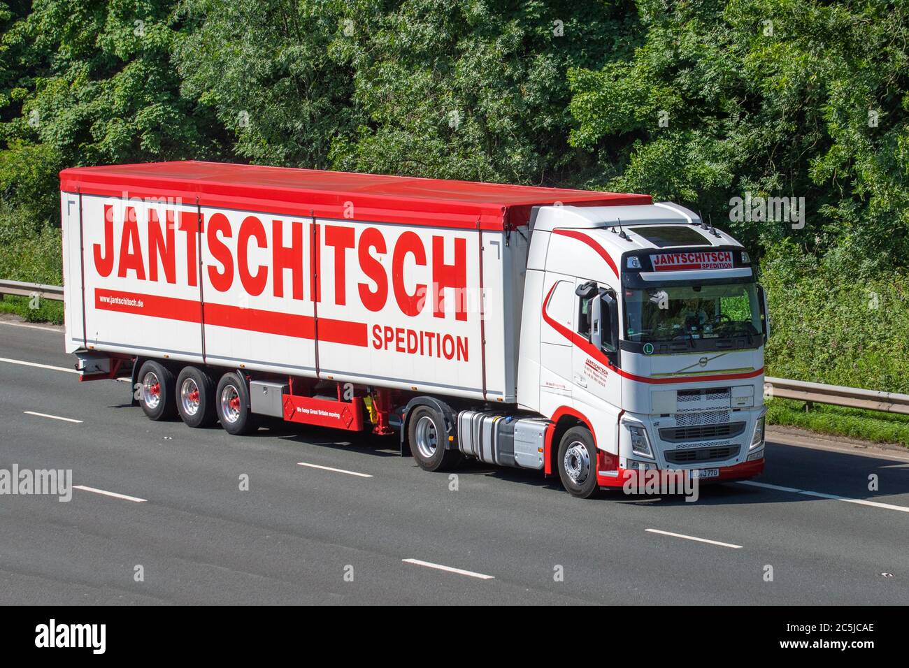 Jantschitsch spedition Haulage delivery trucks, lorry, transportation, articulated truck, cargo carrier, Volvo vehicle, European commercial transport industry HGV, M6 at Manchester, UK Stock Photo