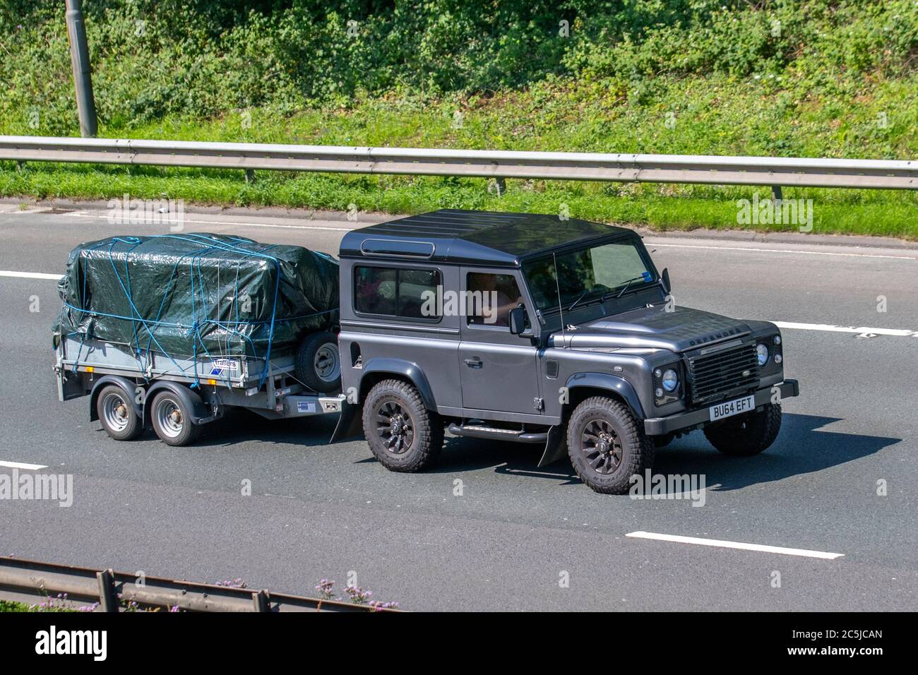 2014 grey Land Rover Defender 90 XS TD; Vehicular traffic moving