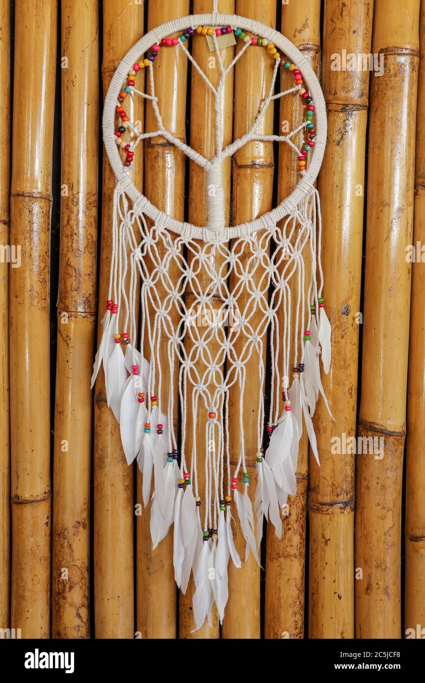 Dream catcher, decorated with white feathers and wooden beads, on a ...