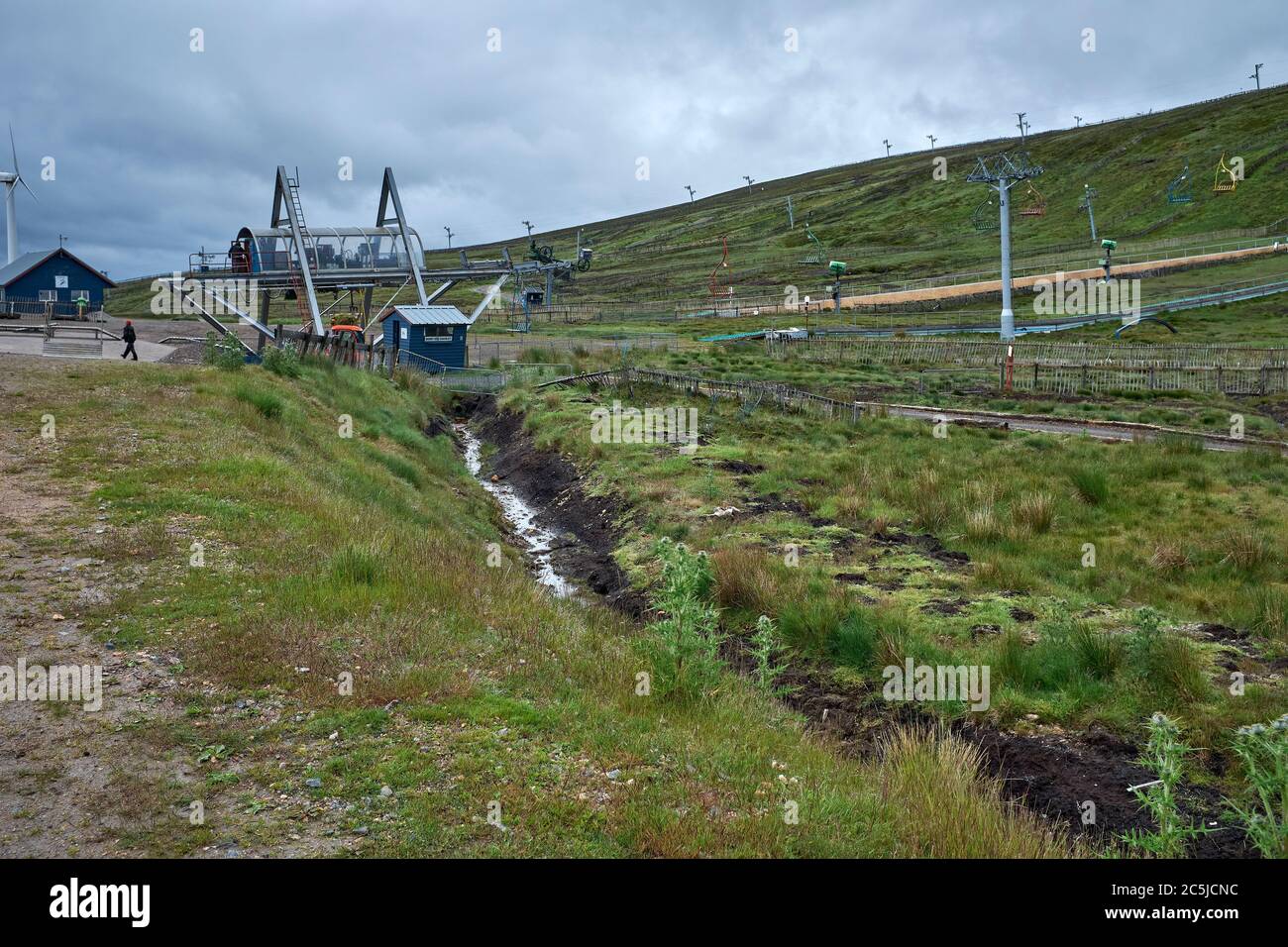 During a rainy July and out of season, the POMA chairlift and gantries stand idle at the Lecht Ski Centre Stock Photo