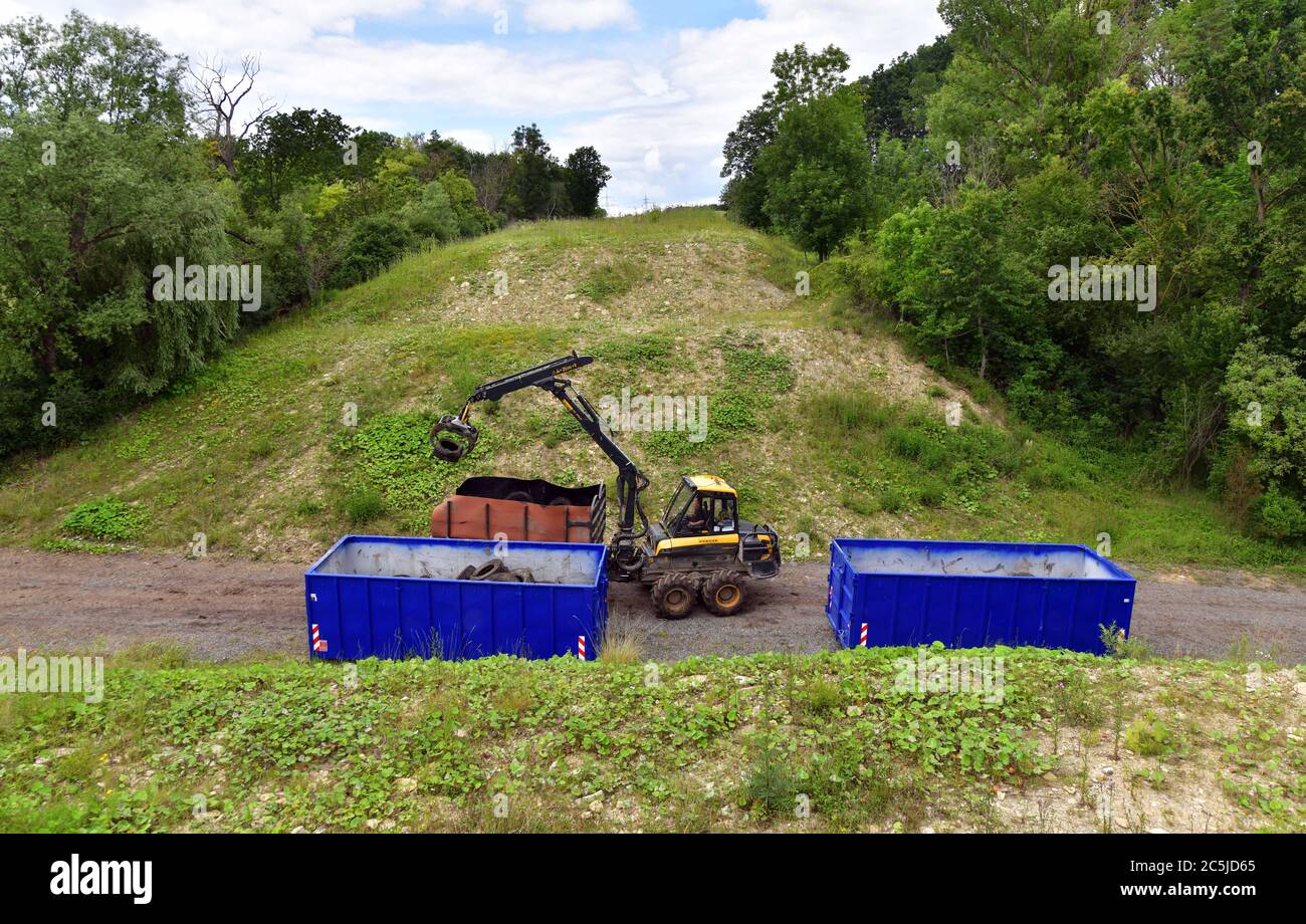 Schorba, Germany. 03rd July, 2020. Heavy technology is used to remove a contaminated landfill site with around 1500 tyres. In the Leutra Valley, work has begun on clearing the landfill site for used tyres that is well known in the country. The costs amount to about 50,000 Euro. The ministry said that the forest area had been used as a wild waste dump since the mid-1950s. Credit: Martin Schutt/dpa/Alamy Live News Stock Photo