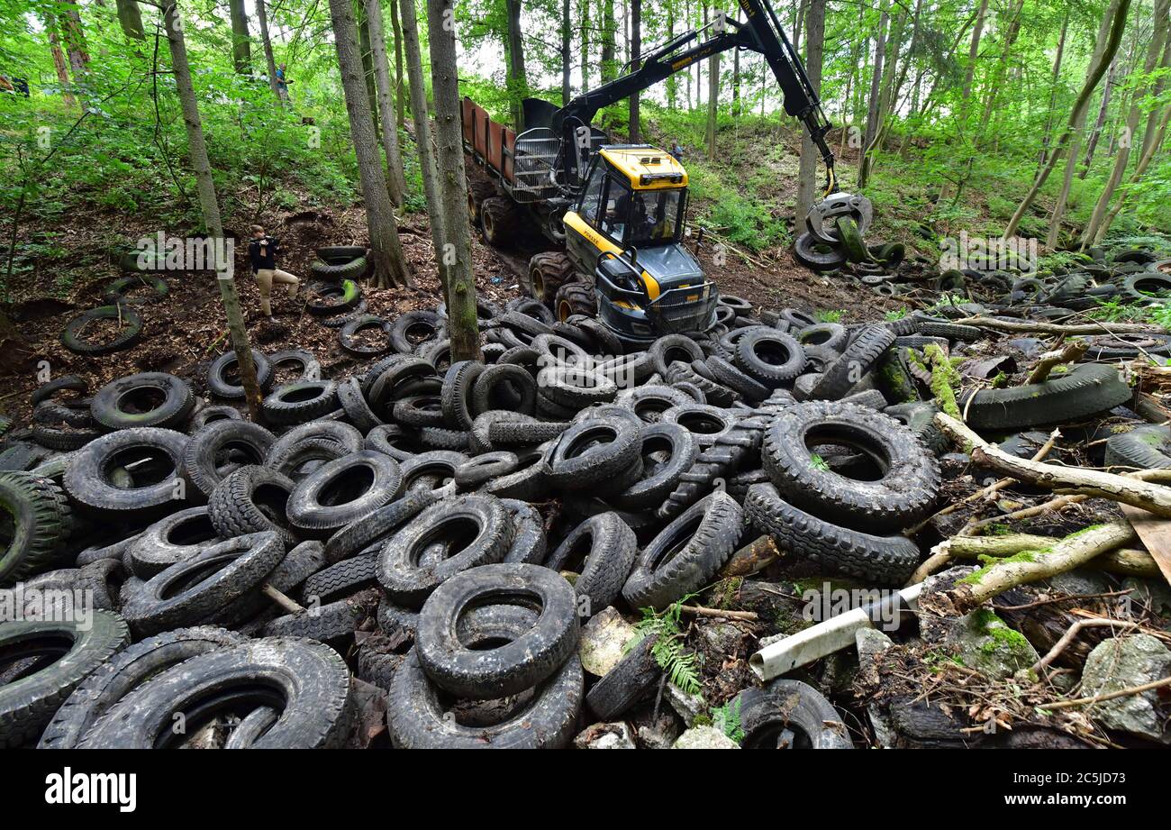 Schorba, Germany. 03rd July, 2020. Heavy technology is used to remove a contaminated landfill site with around 1500 tyres. In the Leutra Valley, work has begun on clearing the landfill site for used tyres that is well known in the country. The costs amount to about 50,000 Euro. The ministry said that the forest area had been used as a wild waste dump since the mid-1950s. Credit: Martin Schutt/dpa/Alamy Live News Stock Photo