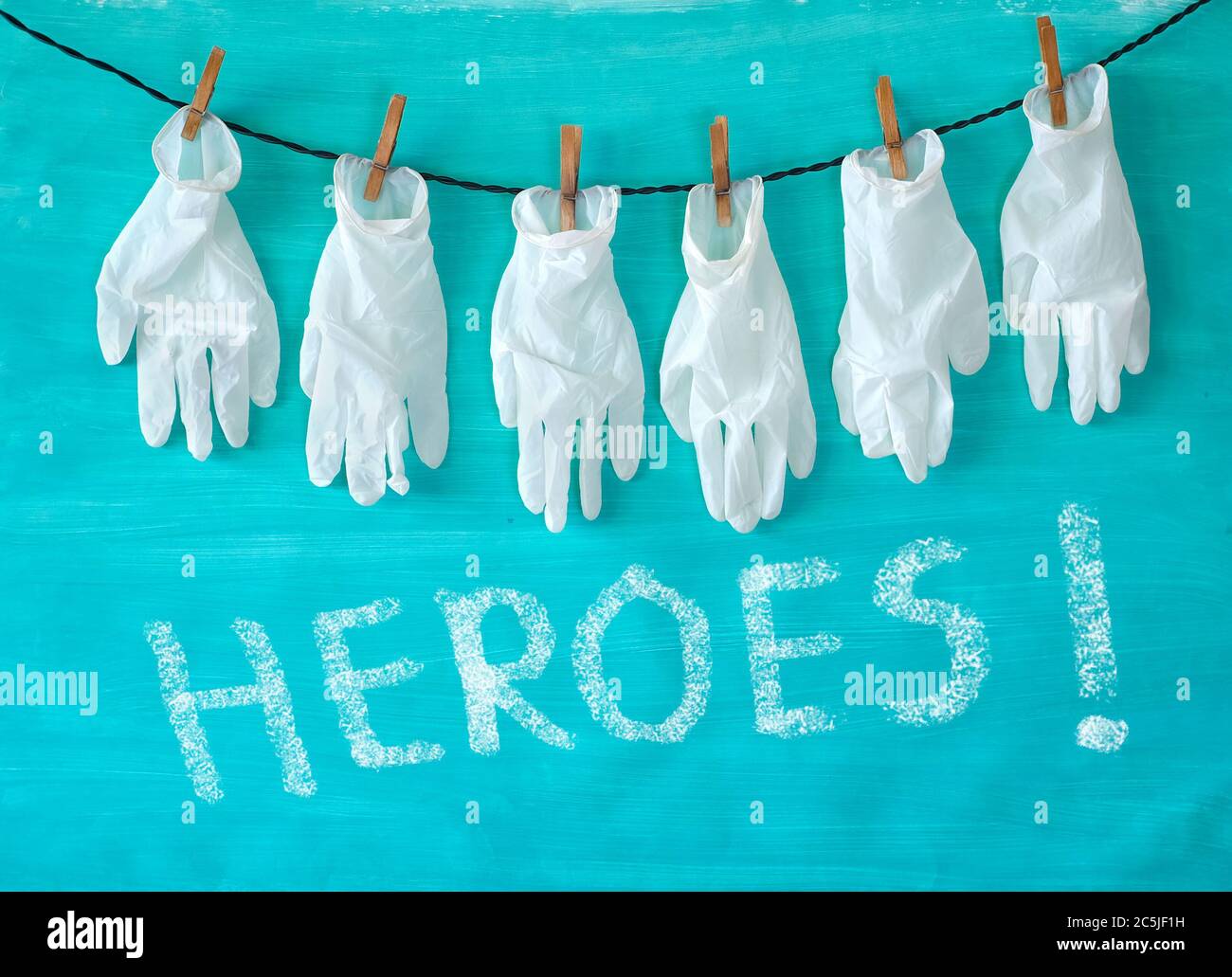 Giving respect to the health care system, symbol picture,medical gloves ...