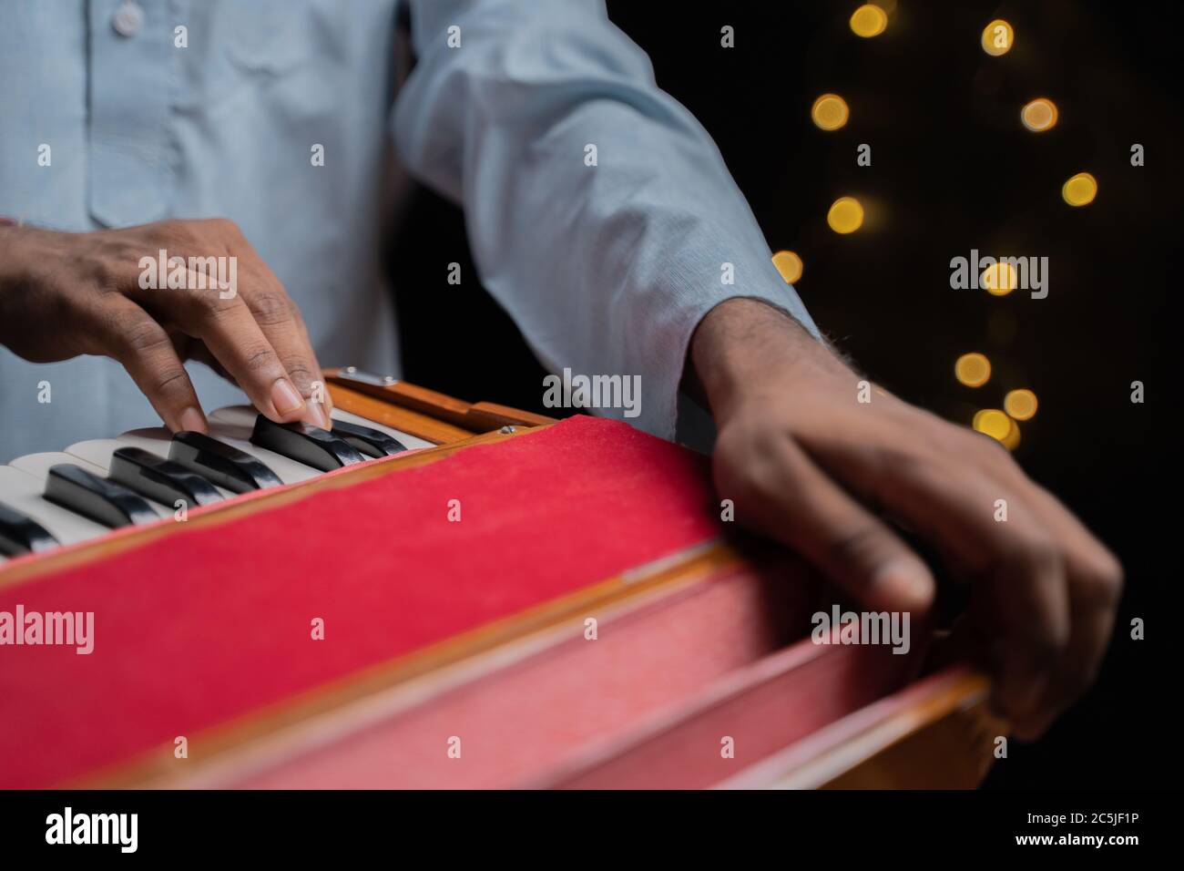 Close up of Hands playing Indian music instrument Harmonium Stock Photo
