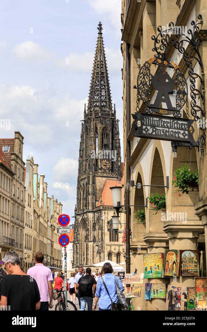 People and shoppers in Prinzipalmarkt, with the gothic spire of St Lamberts church behind, Münster in Westfalen, North Rhine-Westphalia, Germany Stock Photo