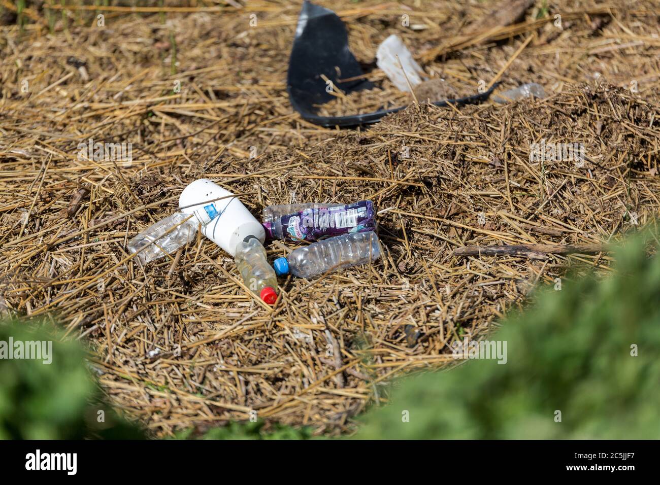 Suffolk, UK April 15 2020: washed up garbage on a river bank. Empty used dirty plastic bottles. Environmental pollution. Ecological problem Stock Photo