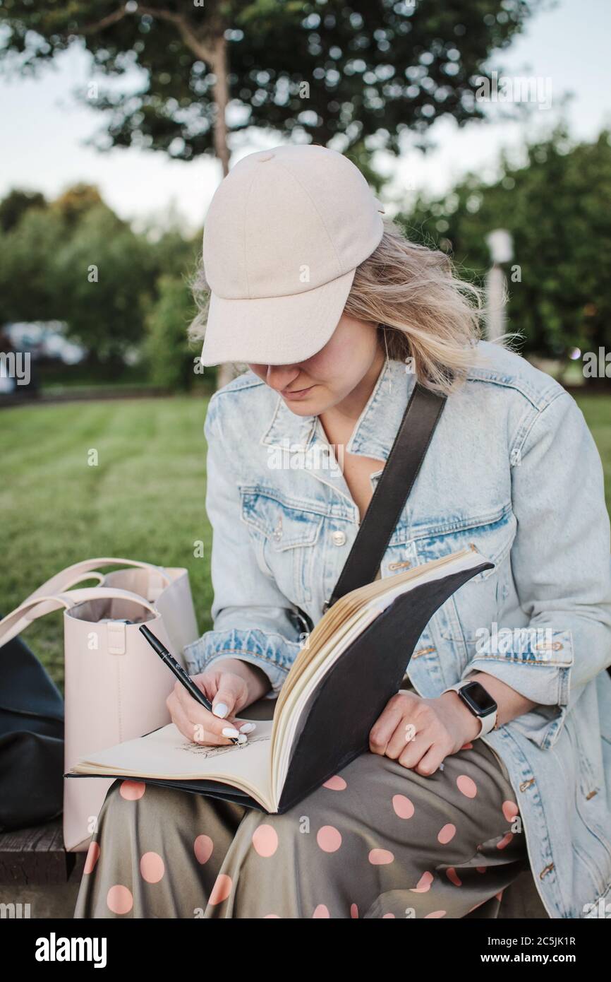 https://c8.alamy.com/comp/2C5JK1R/young-beautiful-girl-draws-in-a-park-outline-in-a-sketchbook-drawing-lesson-2C5JK1R.jpg