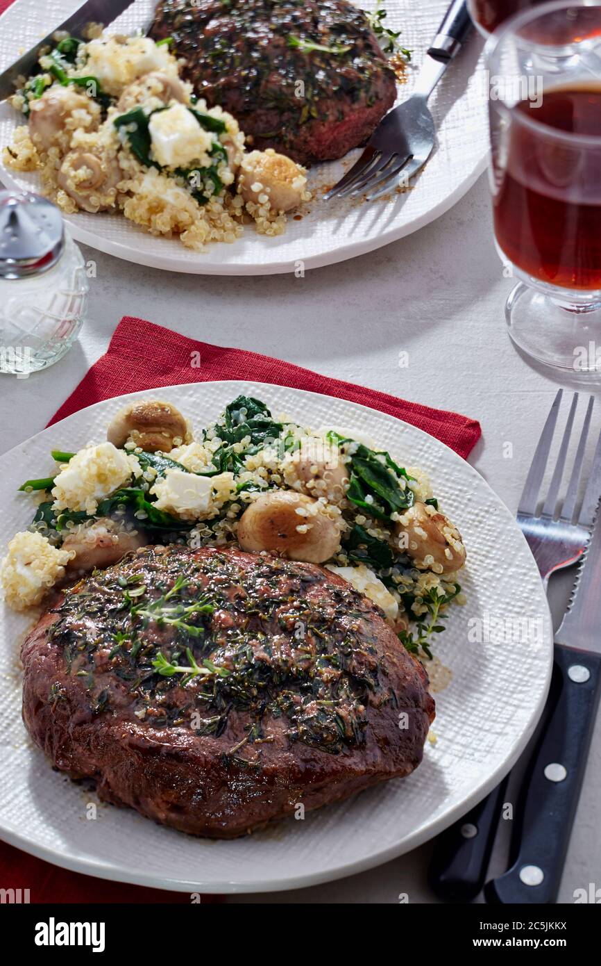 Thyme and anchovy beef steaks with quinoa, feta, mushrooms and spinach