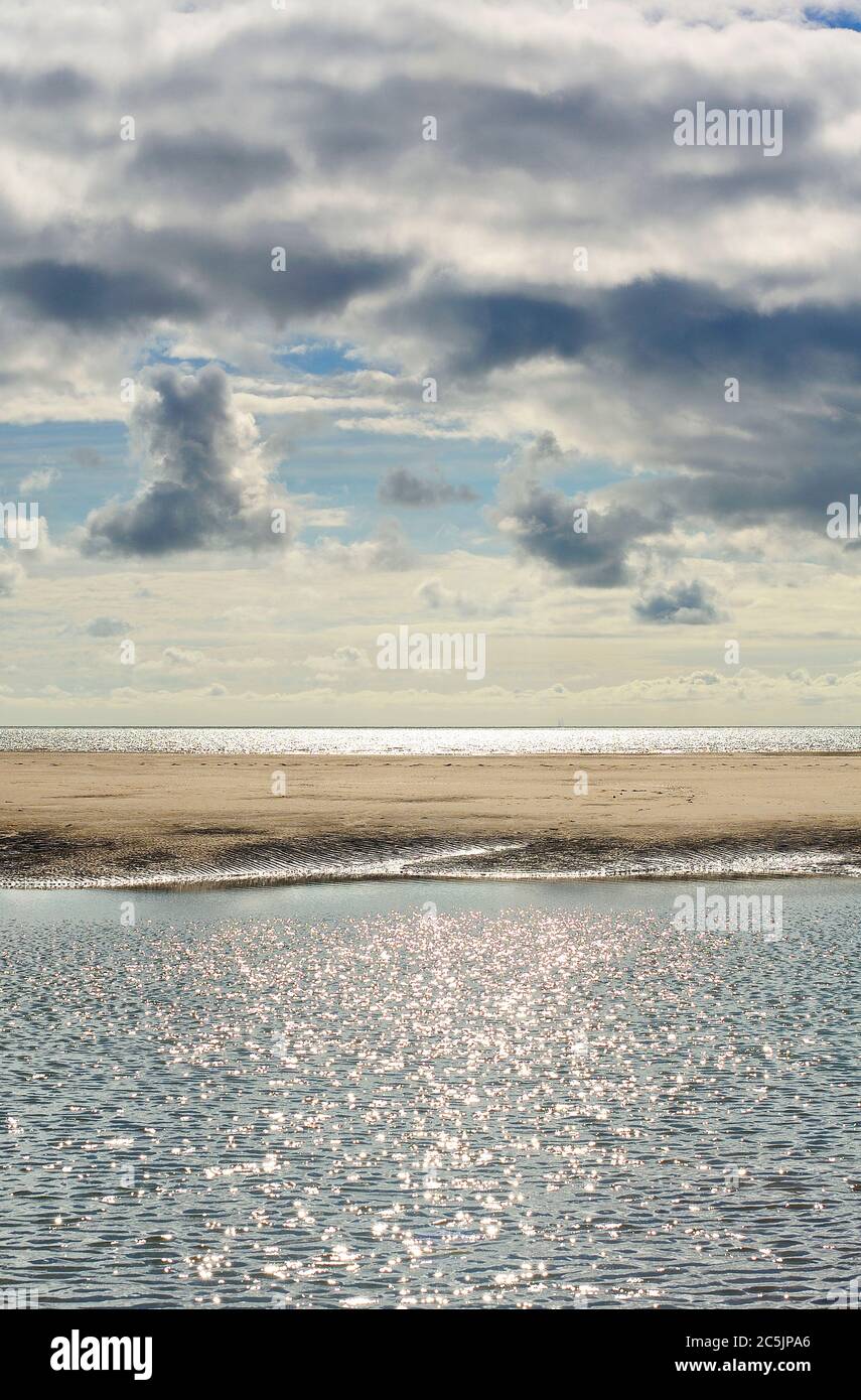 Sun shining on sea through dark storm clouds Stock Photo - Alamy