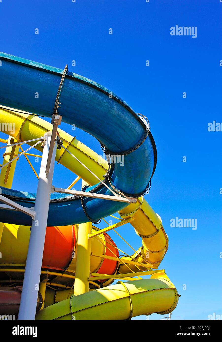 External yellow and blue water slide tubes on water park centre Stock