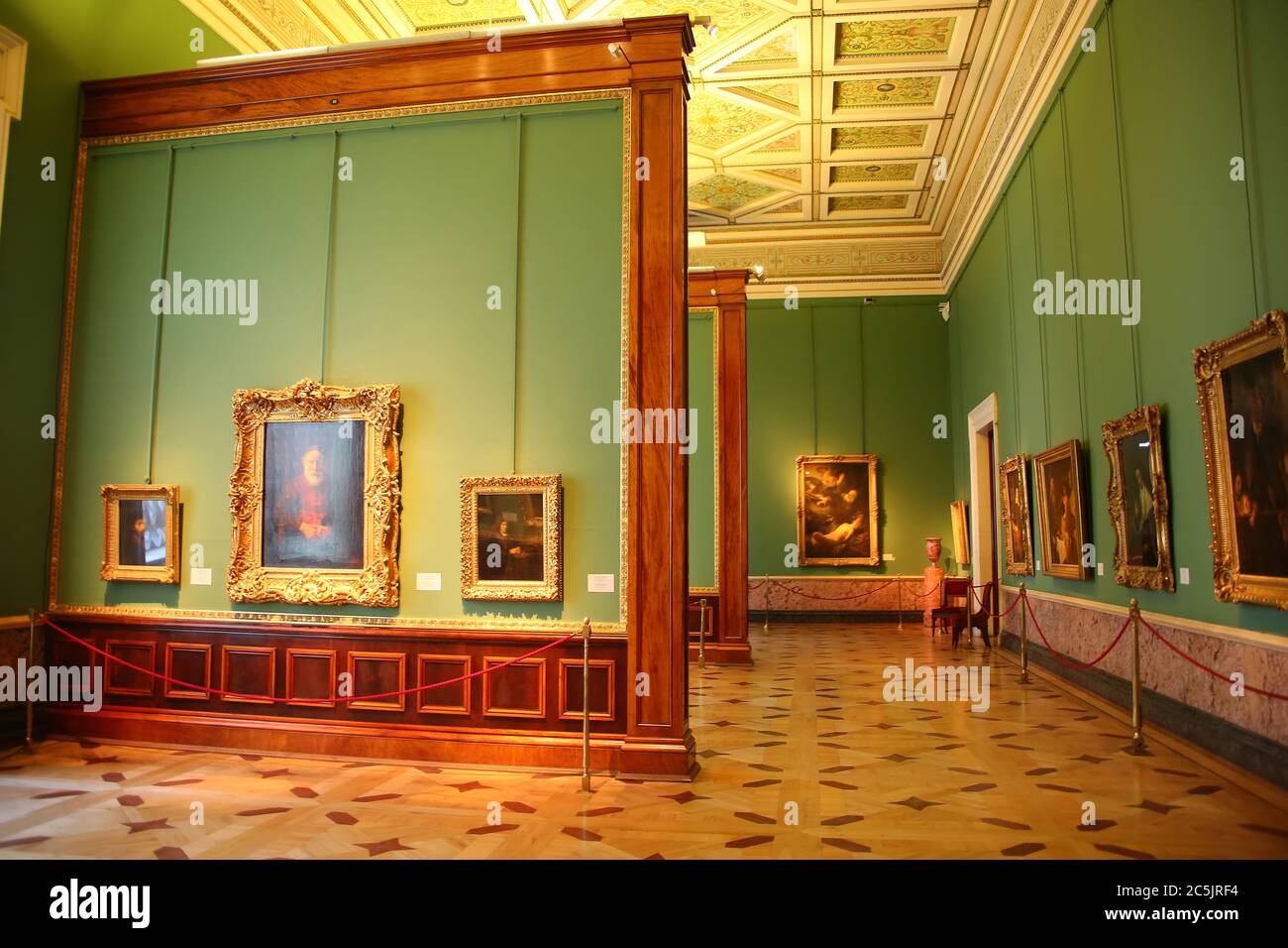 Beautiful green painted Rembrandt Hall with many paintings hanging on the wall, State Hermitage Museum, St Petersburg, Russia. Stock Photo