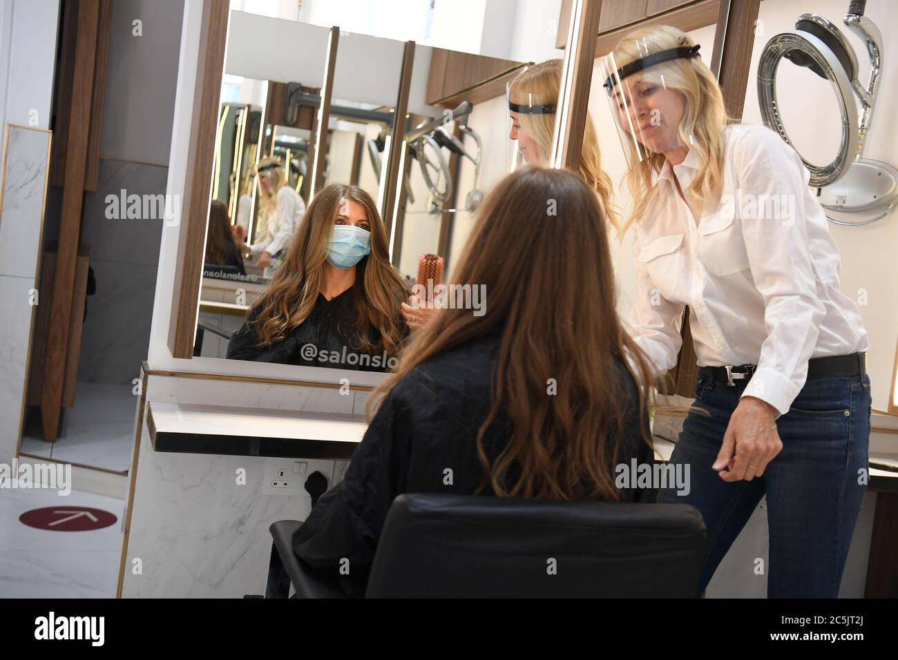 Co-founder Belle Cannon practises on a mock client at Salon Sloane in Chelsea, London, as they prepare to reopen to the public on Saturday, when the lifting of further lockdown restrictions in England comes into effect. Stock Photo