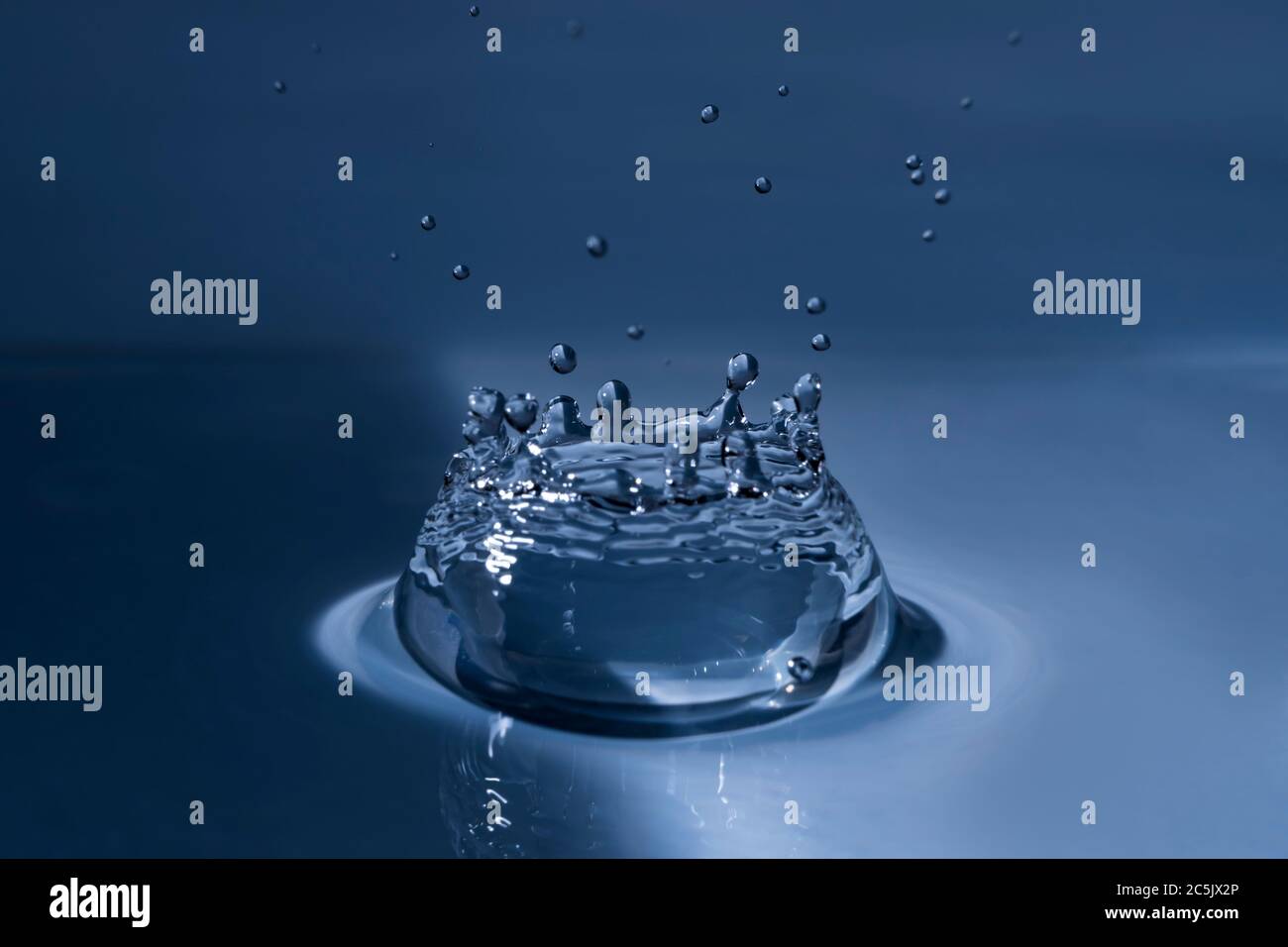 Splashing water drop hitting water surface Stock Photo Alamy