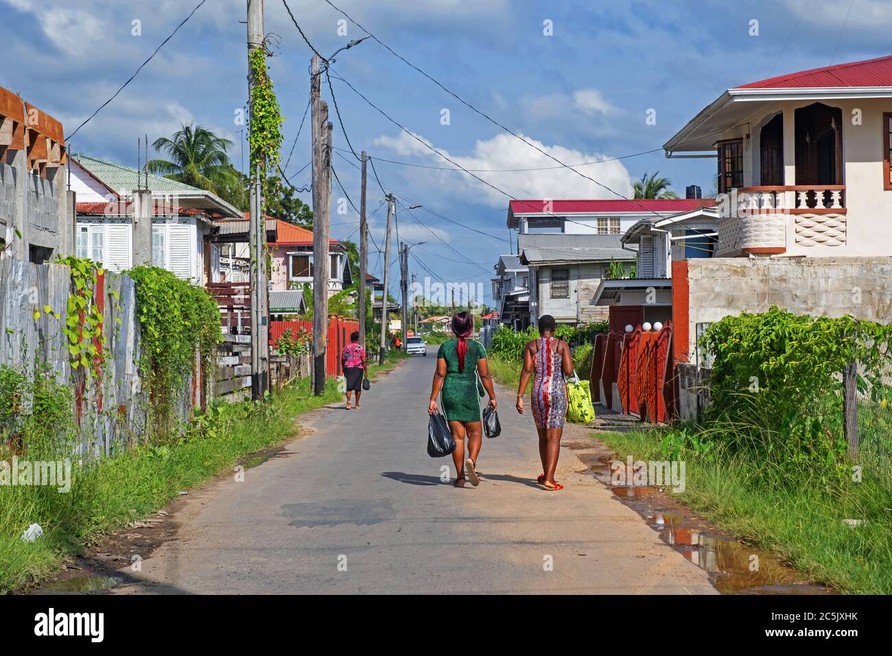 Local black women walking down street in New Amsterdam, East Berbice