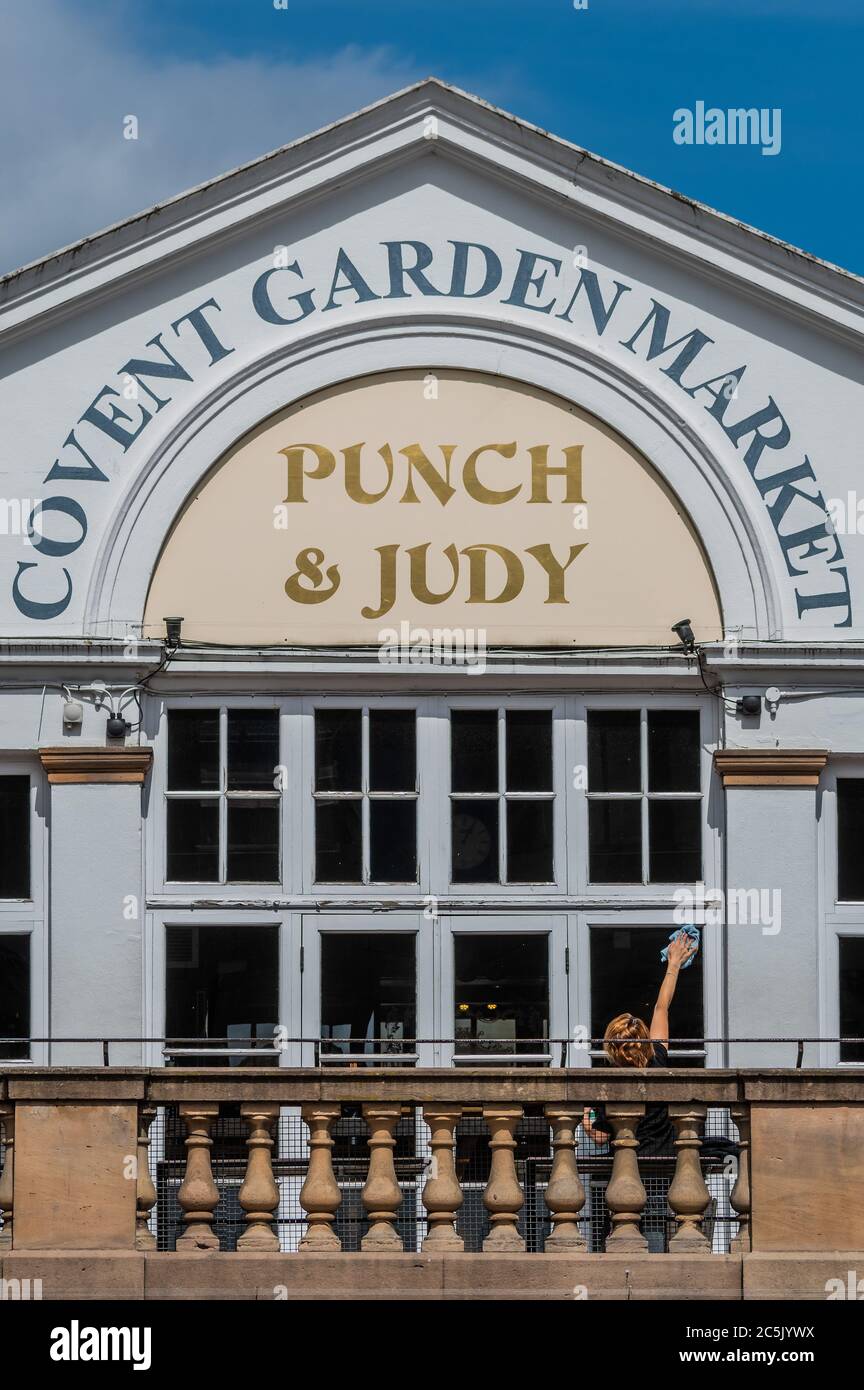 London, UK. 03rd July, 2020. Windows are cleaned at the Punch and judy Pub - Covent Garden prepares for the new re-opening on July $th (tomorrow) with signage and hand sanitiser - albeit many places are already open, if only partially. The city opens up following the easing of Coronavirus (COVID-19) lock-down. Credit: Guy Bell/Alamy Live News Stock Photo