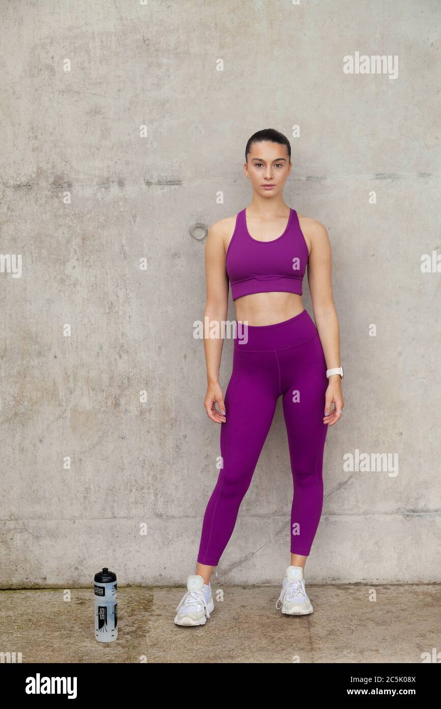 Portrait of a athletic young woman in leggings and sports bra Stock Photo -  Alamy