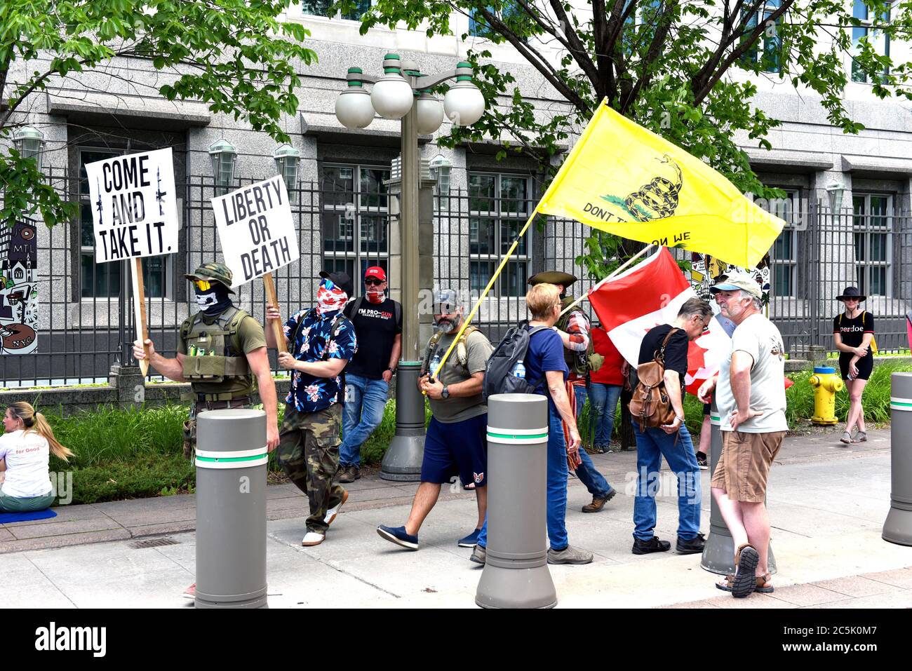 Ottawa, Canada - July 1, 2020: Pro-gun and covid-19 lockdown protesters protest in front of the US Embassy. The annual Canada Day festivities were cancelled due to the Coronavirus pandemic so many used the opportunity to protest their causes on Parliament Hill and the Embassy. Stock Photo
