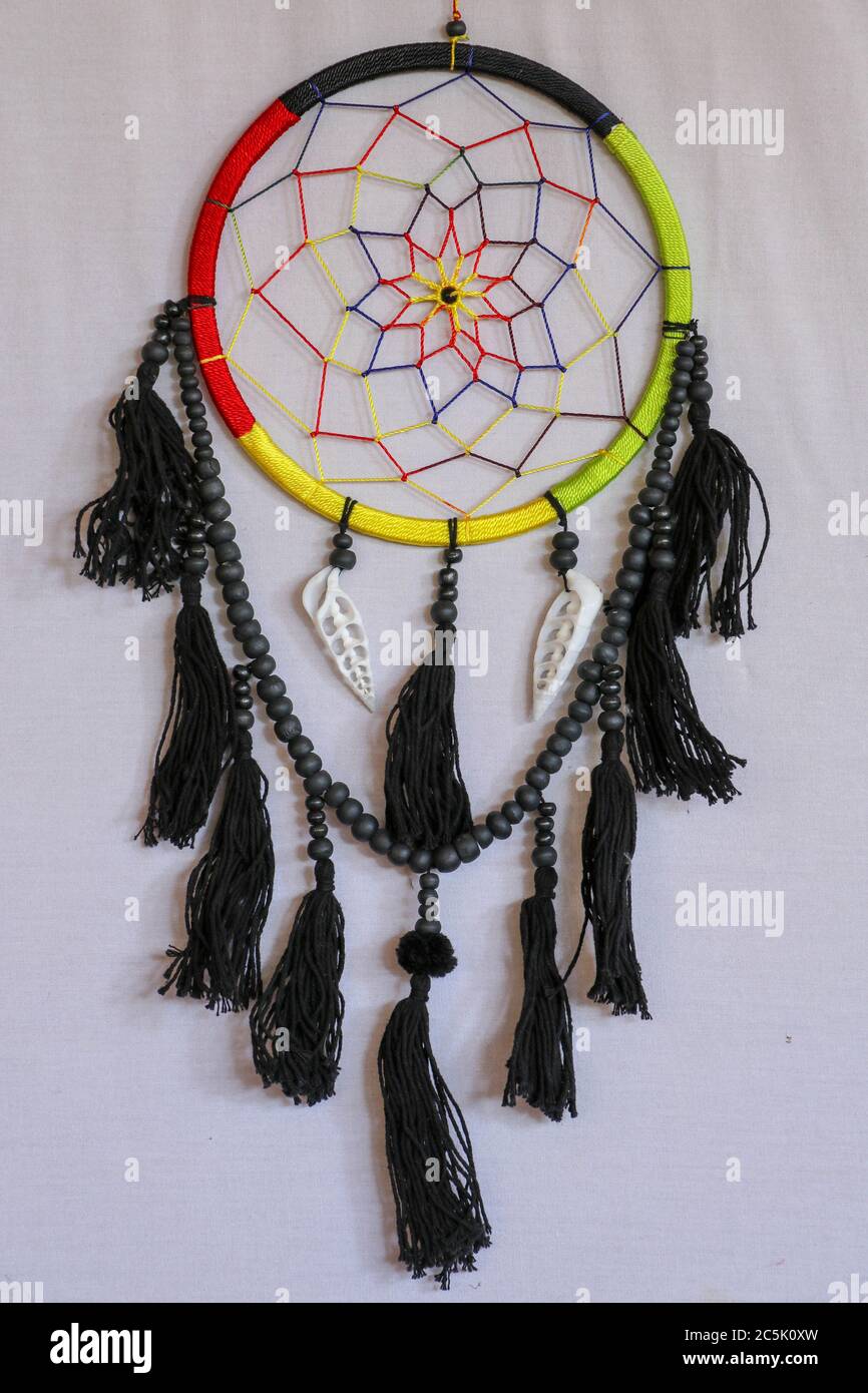 Beautiful multicolored handmade dreamcatcher with sea shells on white background. Stock Photo