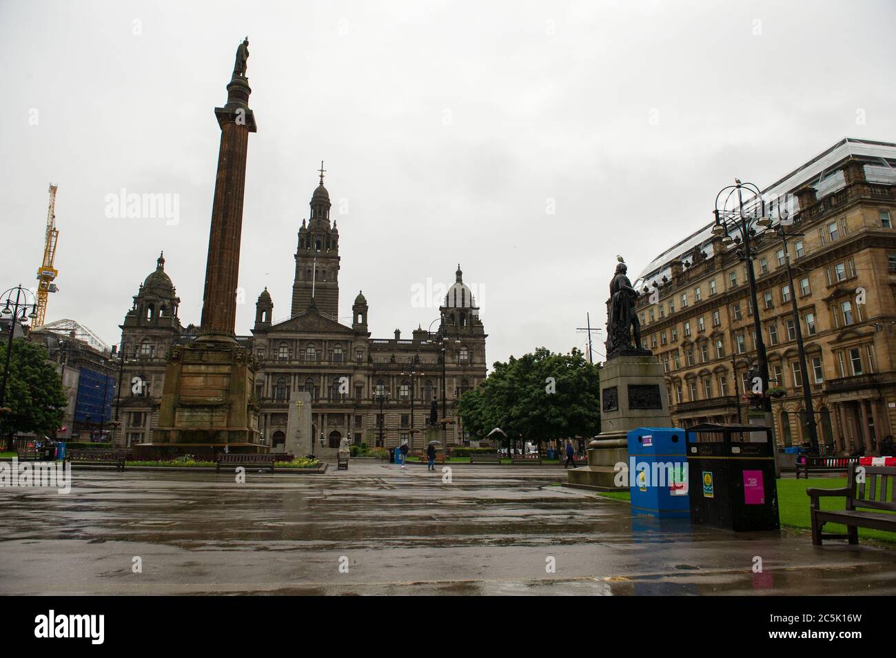 Glasgow, Scotland, UK. 3rd July, 2020. Pictured: A deserted George Square. Buchanan Street shopping area with shoppers braving the pouring rain using umbrellas and face coverings which will become mandatory on 10th July next week. Credit: Colin Fisher/Alamy Live News Stock Photo
