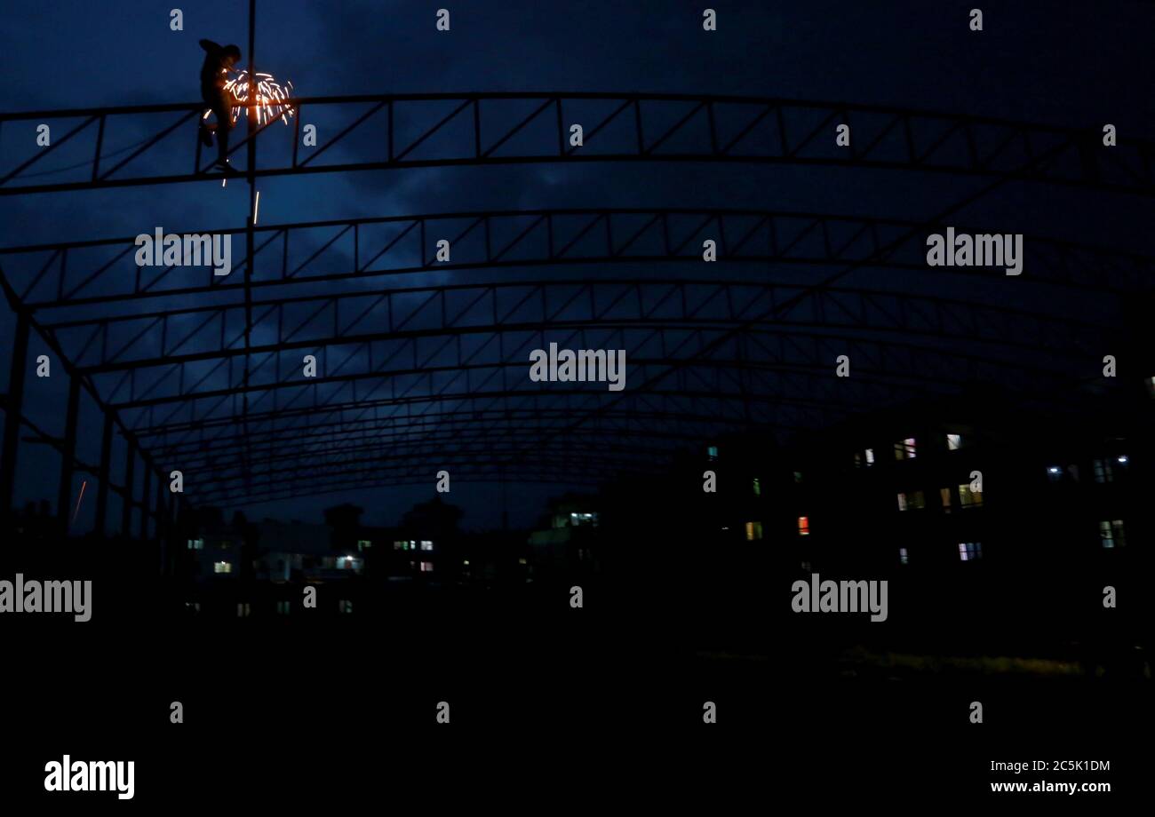 Kathmandu, Nepal. 3rd July, 2020. A worker welds an iron rods together
