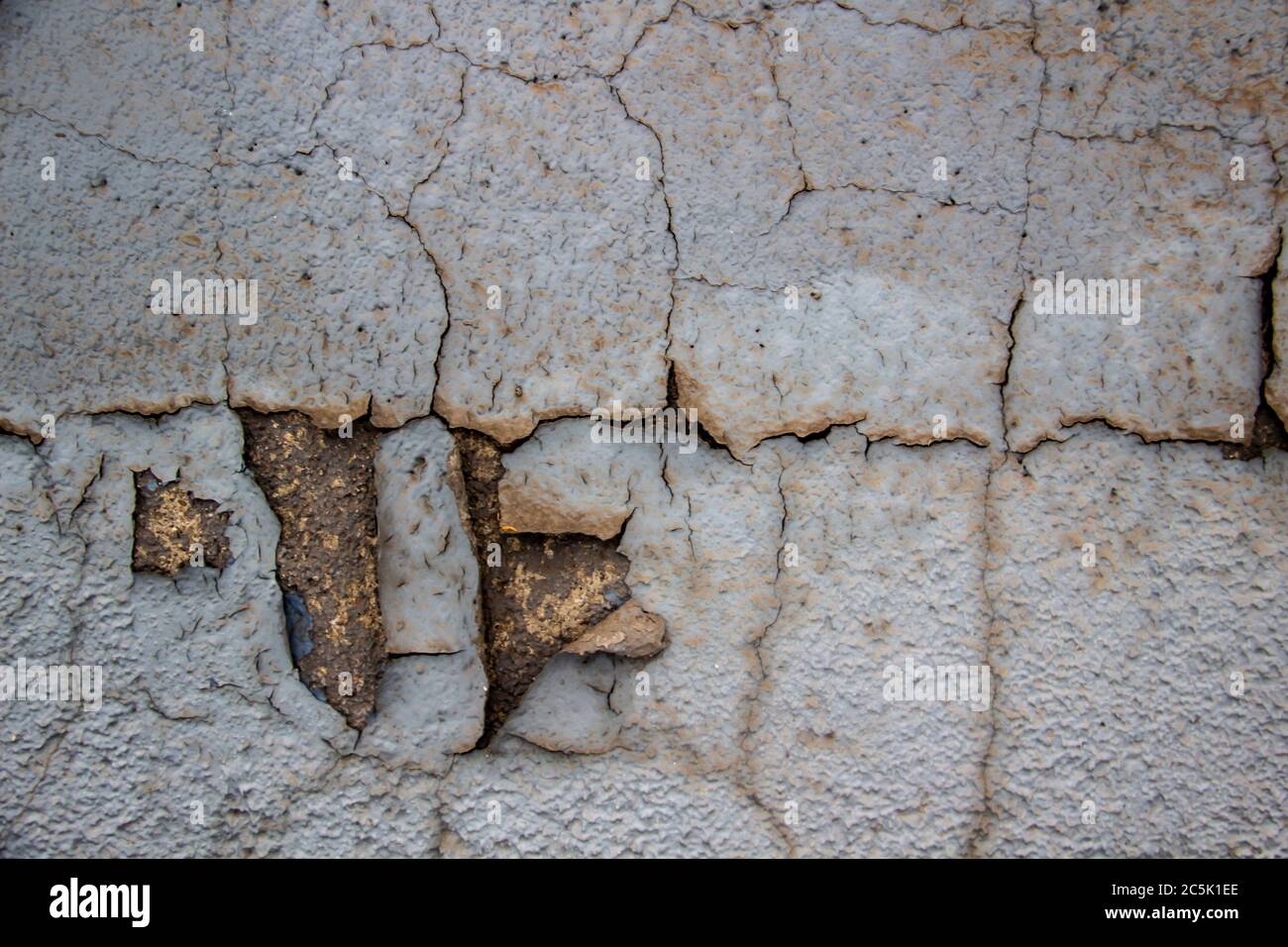 Cracked paint on the wall. A grunge background texture. Old paint on the wall Stock Photo